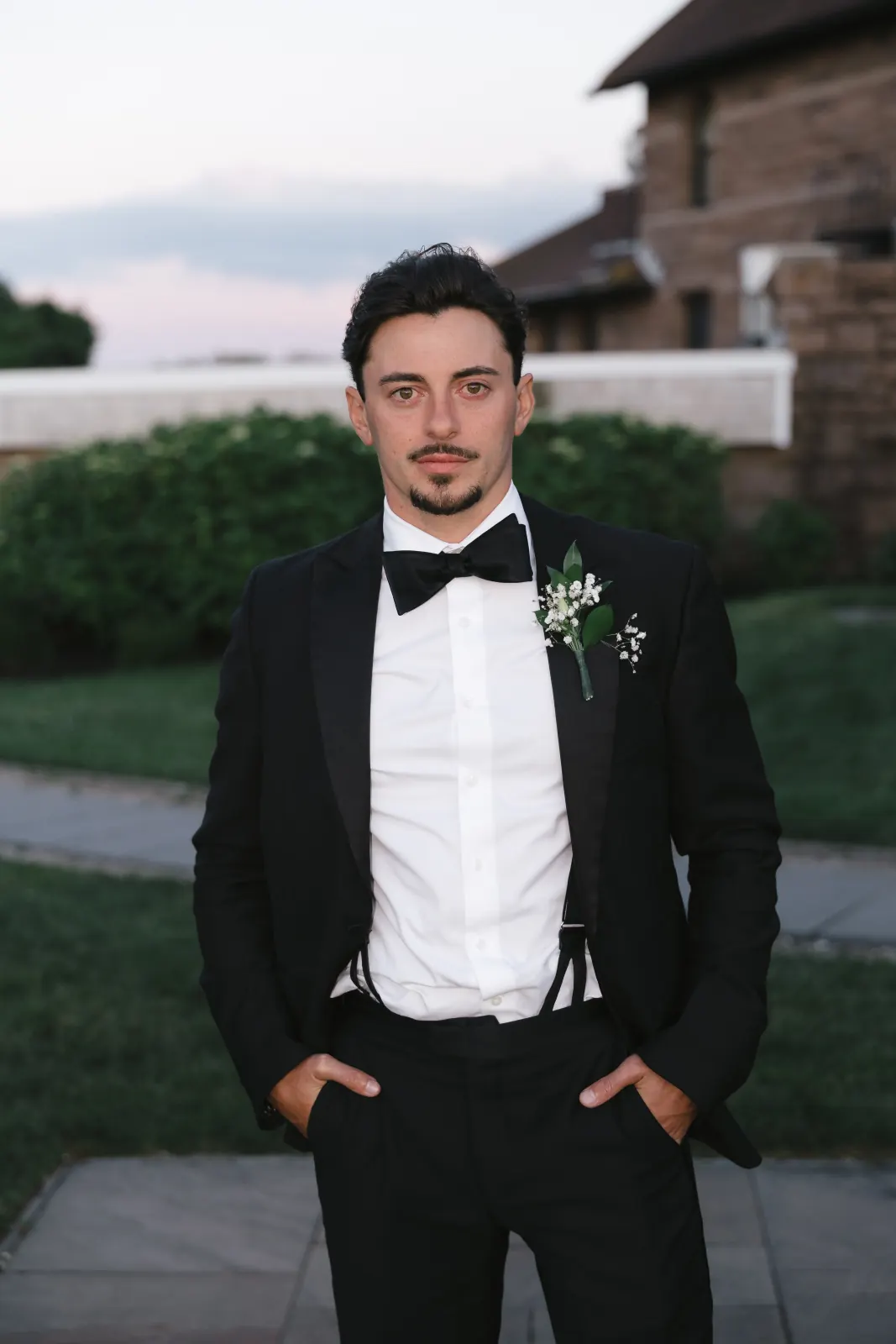 The groom's portrait at dusk on the OceanCliff lawn in Newport
