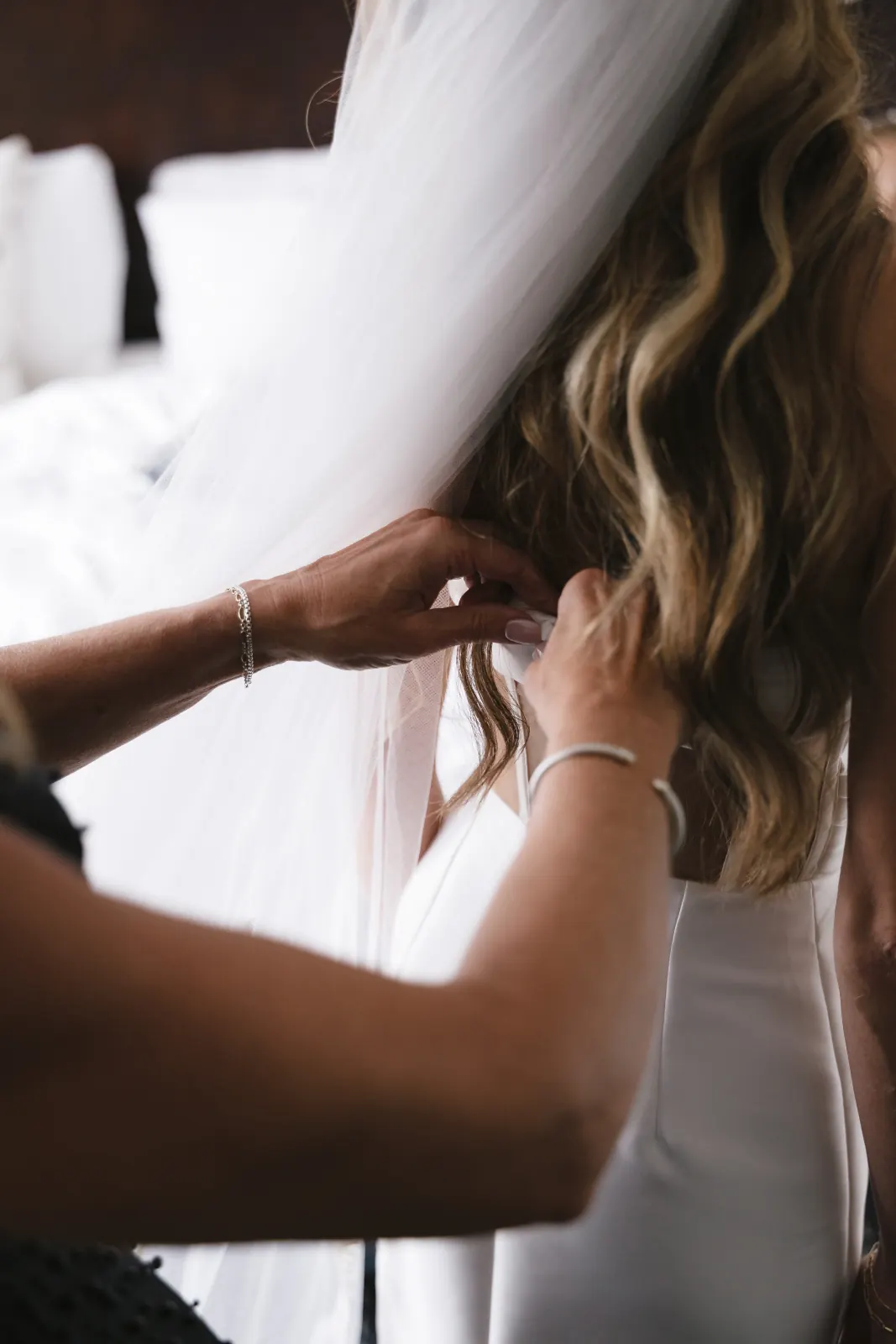 Fastening the wedding gown — getting-ready details in Newport