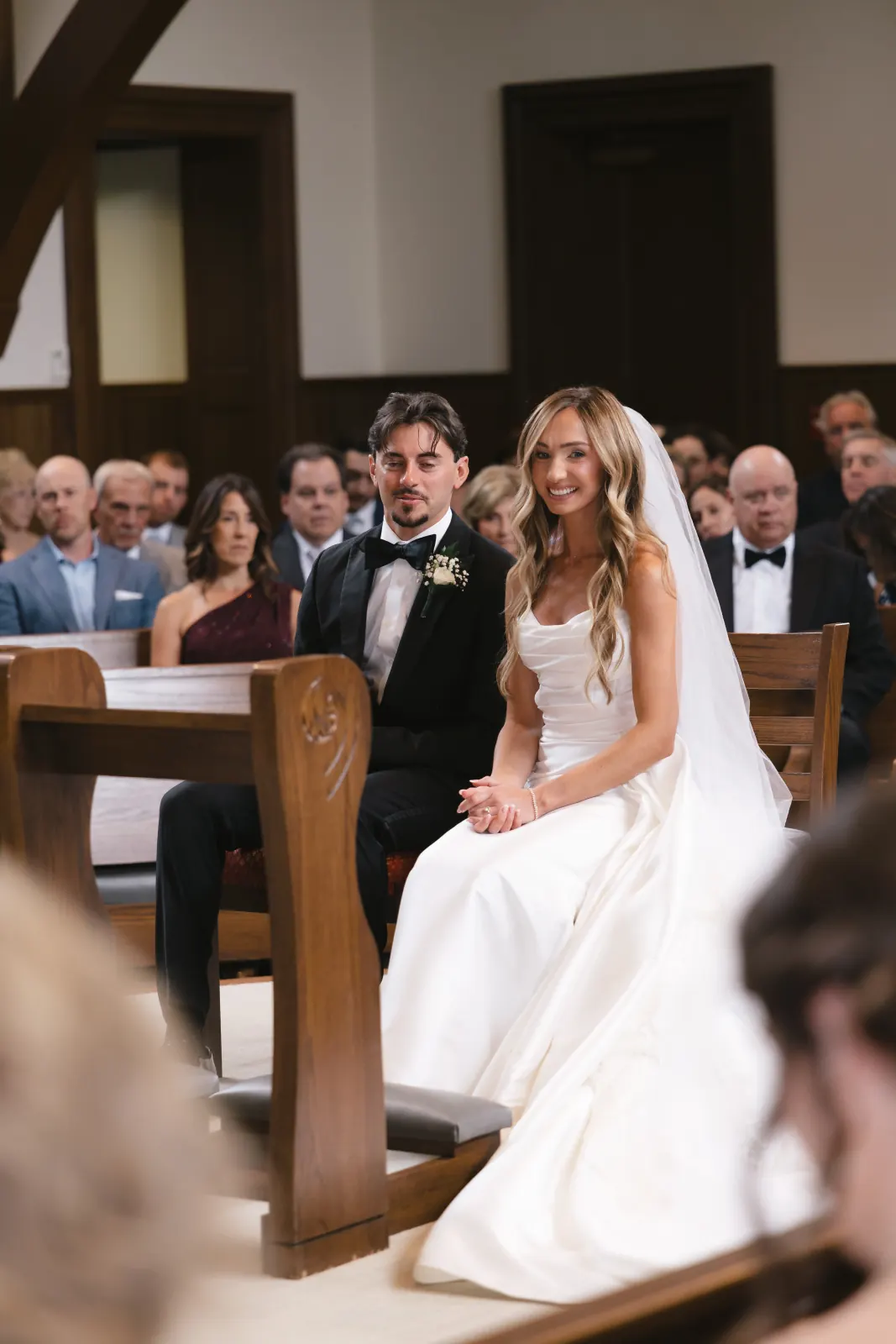 Bride smiles during the ceremony at Our Lady of Mercy Chapel