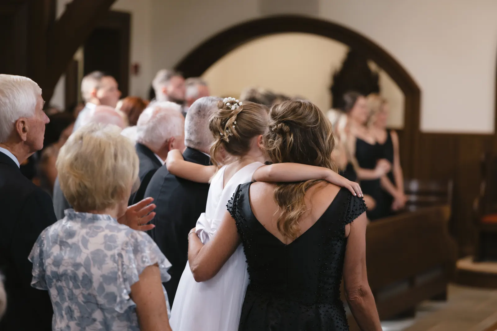 The flower girl shares a hug during the ceremony