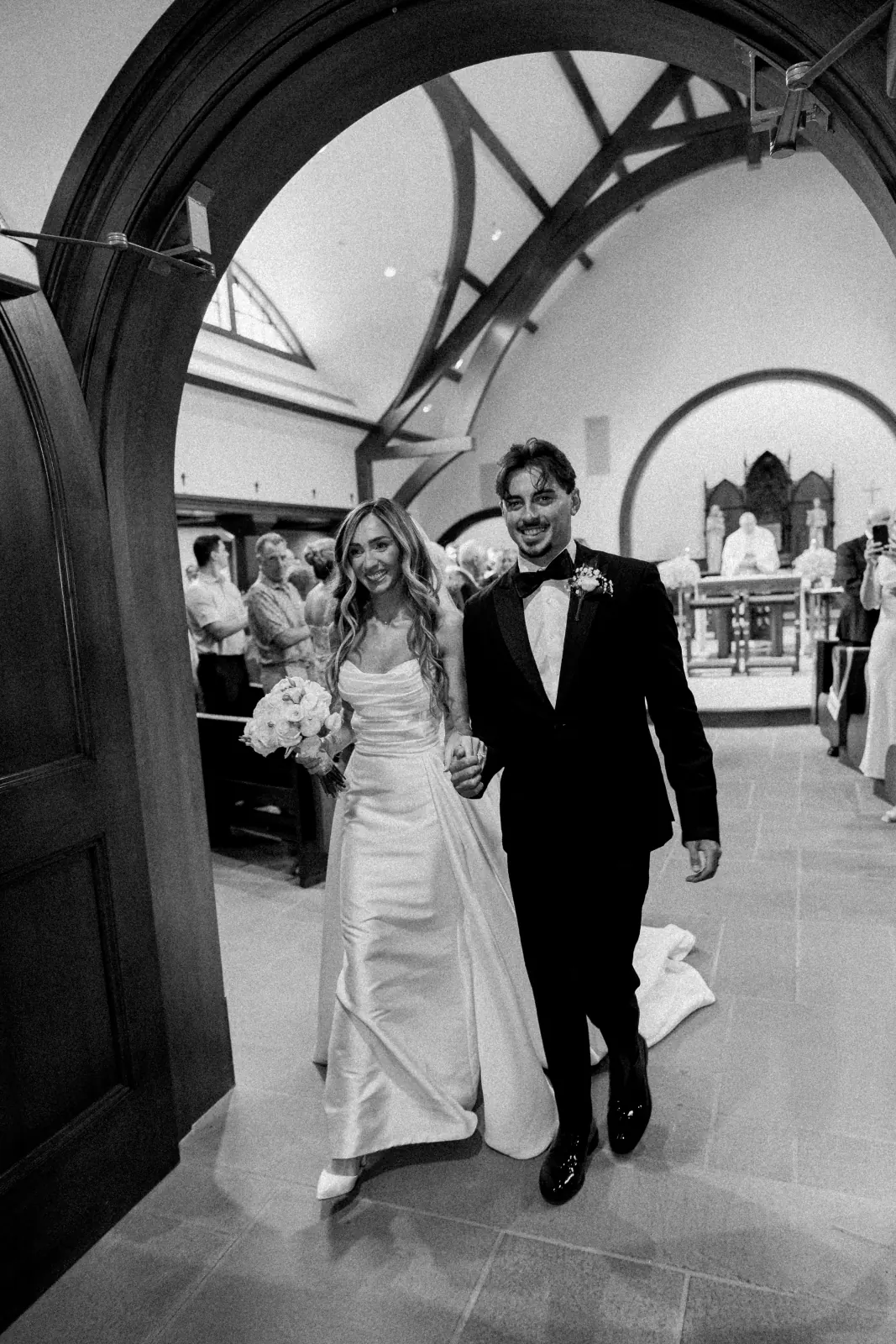 The recessional — Caite and Sean exit through the arched chapel doors