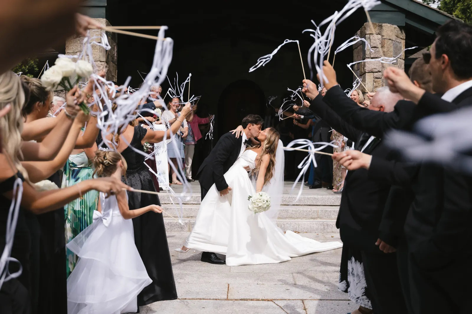 Ribbon-wand send-off on the chapel steps after the Newport ceremony