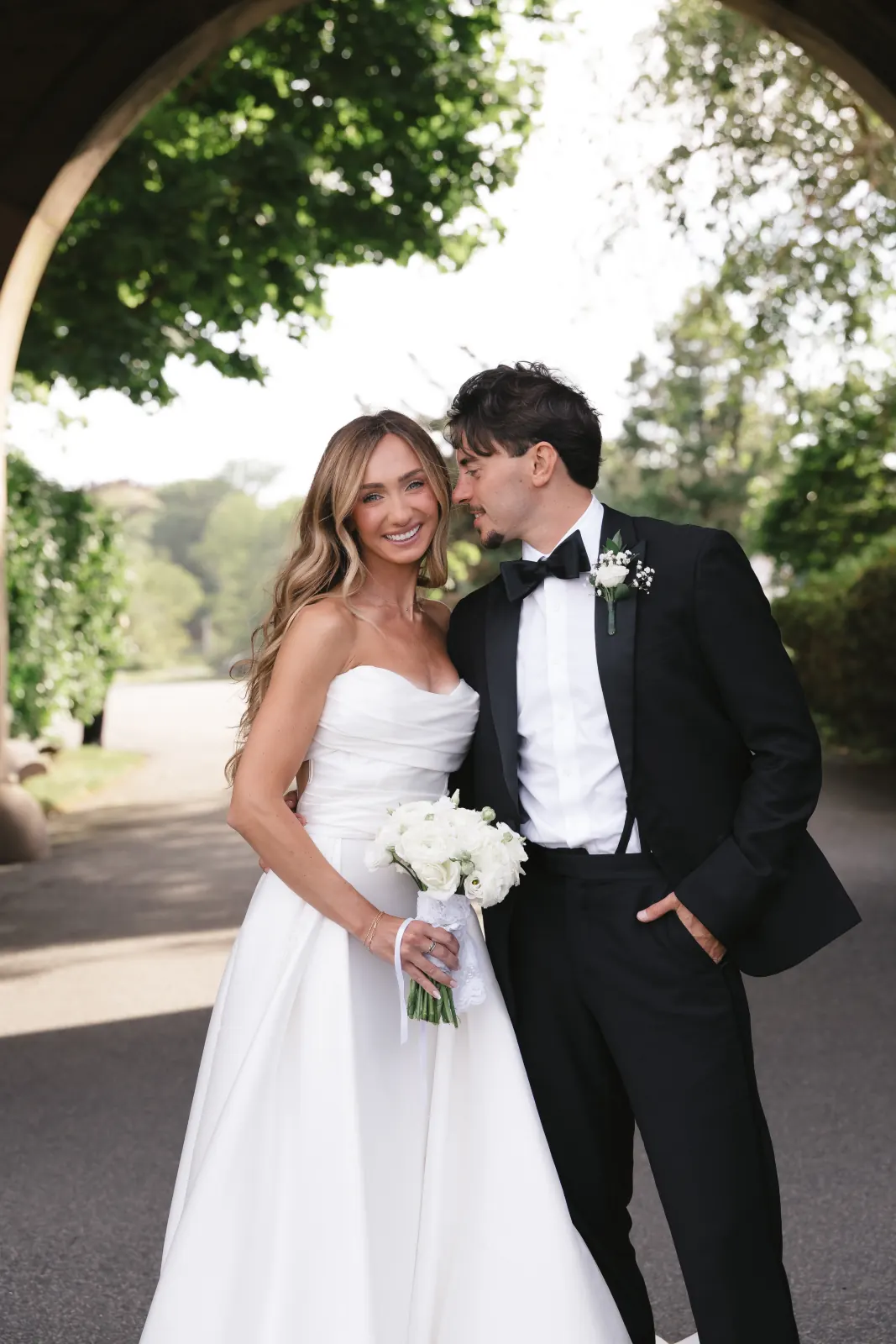 Bride and groom portrait under the stone archway at OceanCliff