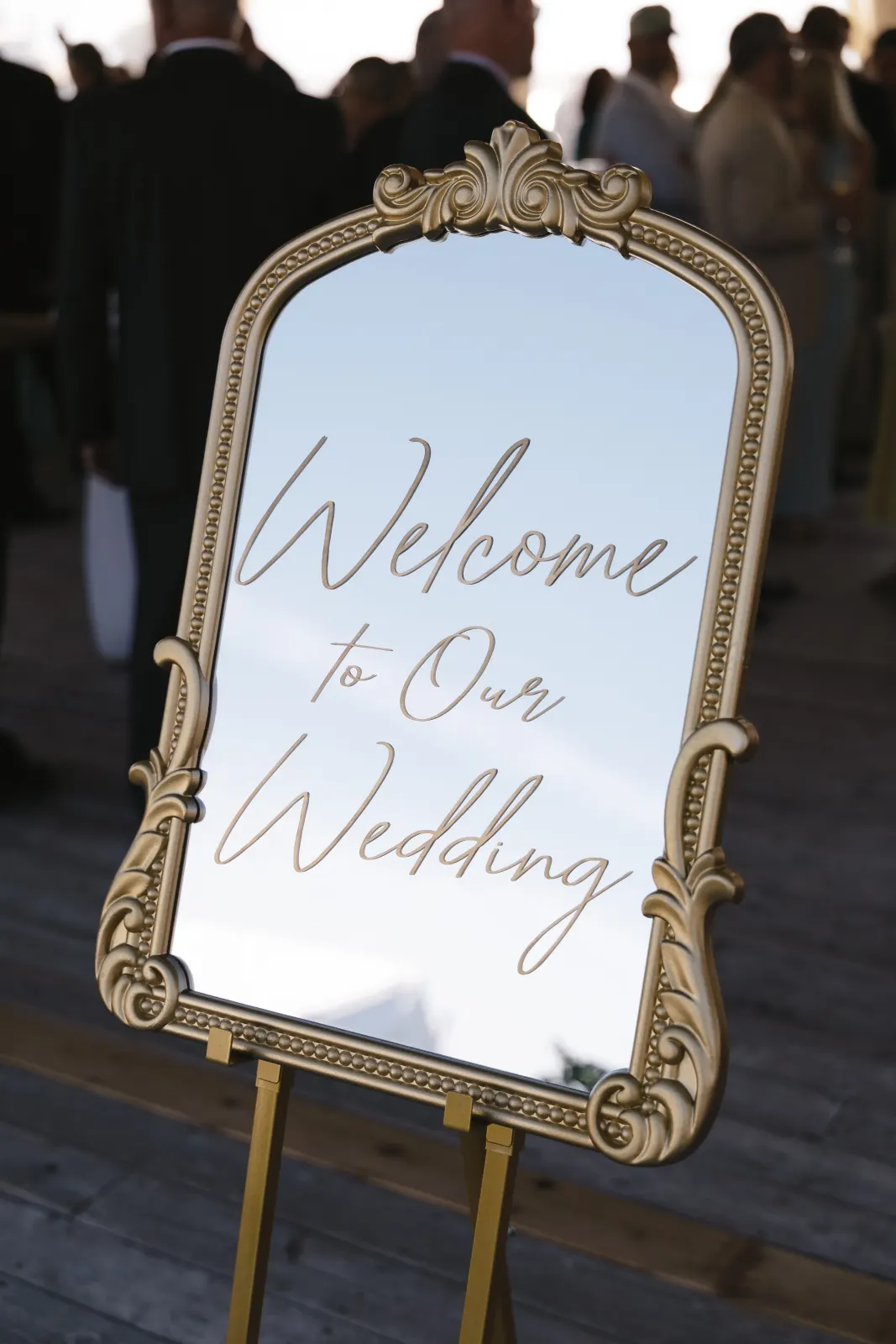 'Welcome to Our Wedding' gold mirror sign at the OceanCliff cocktail hour
