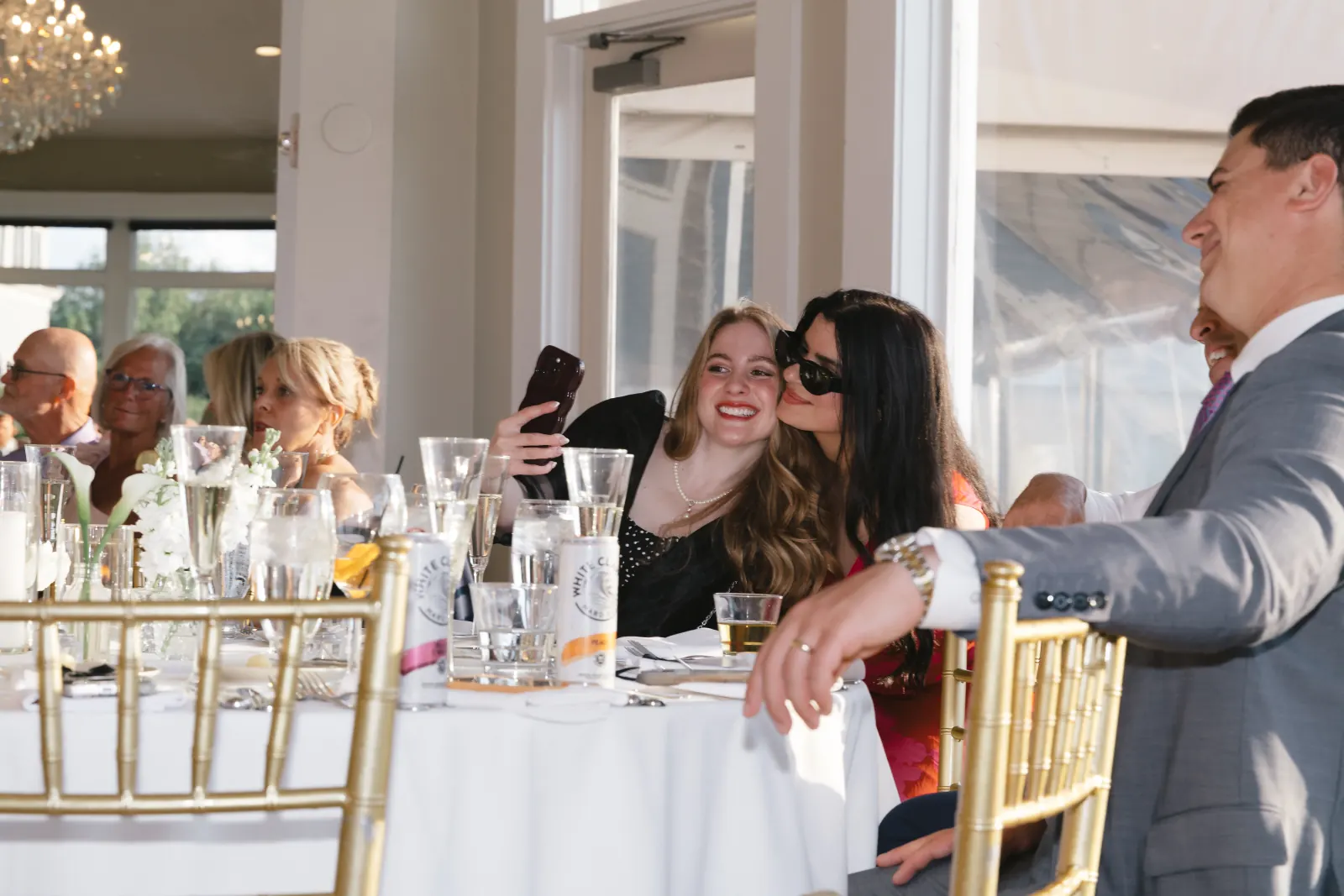 Guests share a candid moment at the OceanCliff wedding reception
