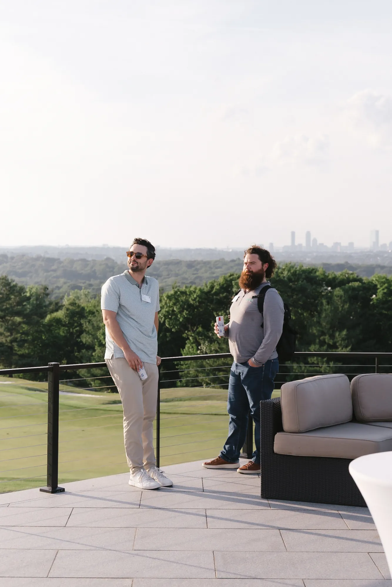 Two guests overlooking the Boston skyline from the Granite Links terrace during the CFMA event, Quincy Massachusetts