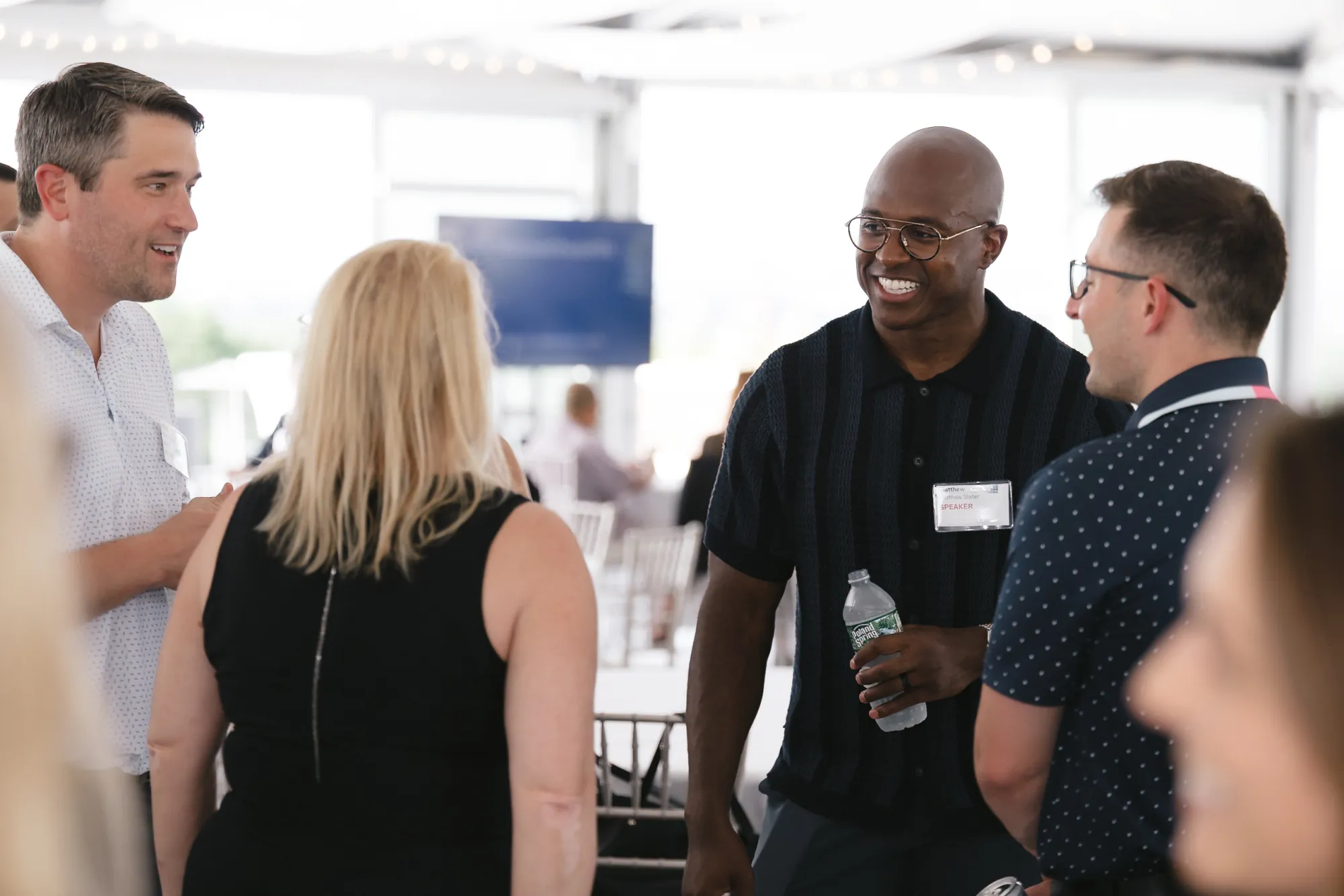 Keynote speaker Matthew Slater talking with attendees during the networking reception at the 2026 CFMA event, Granite Links Golf Club, Quincy Massachusetts