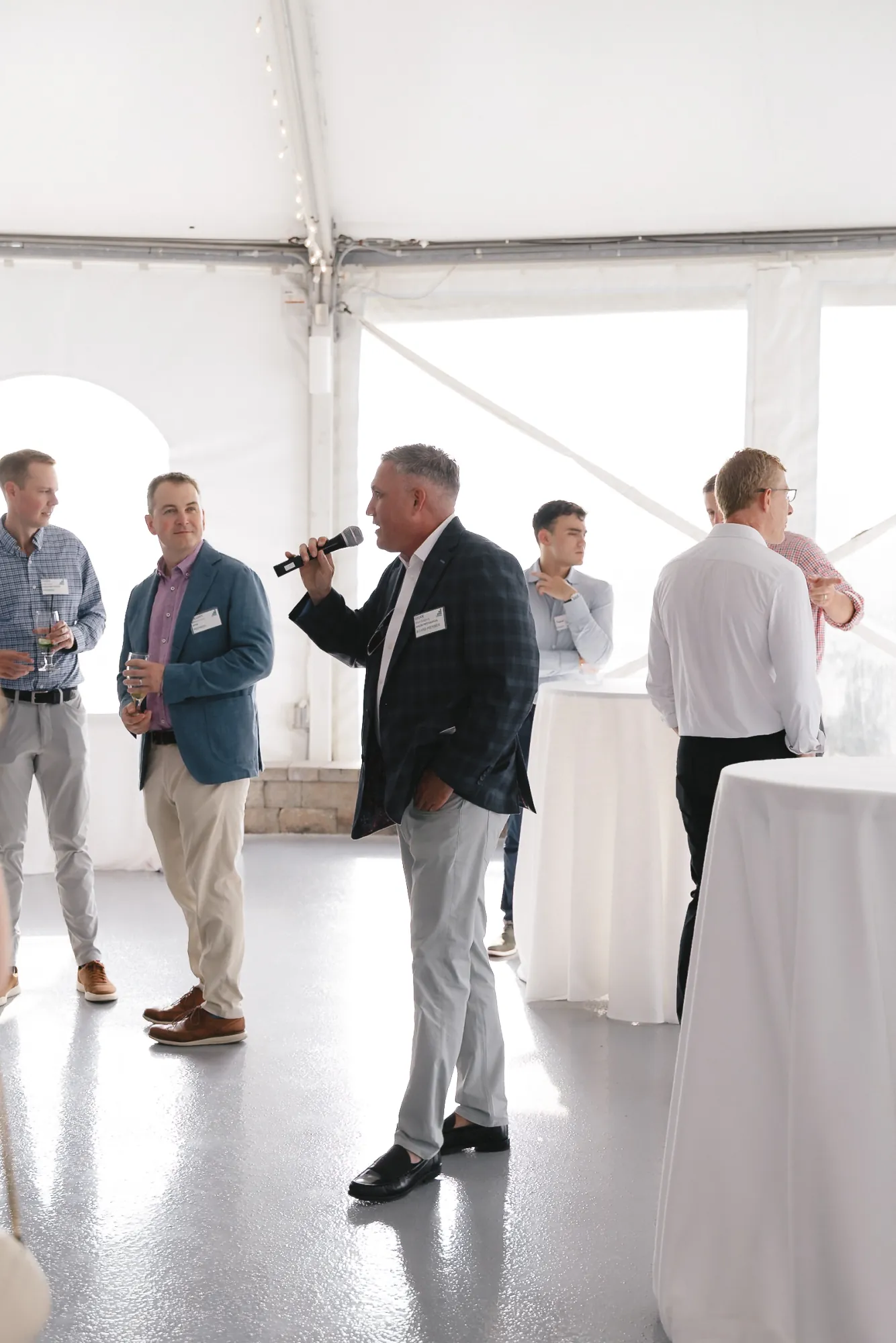 A CFMA member giving remarks with a handheld microphone during the event at Granite Links Golf Club, Quincy Massachusetts