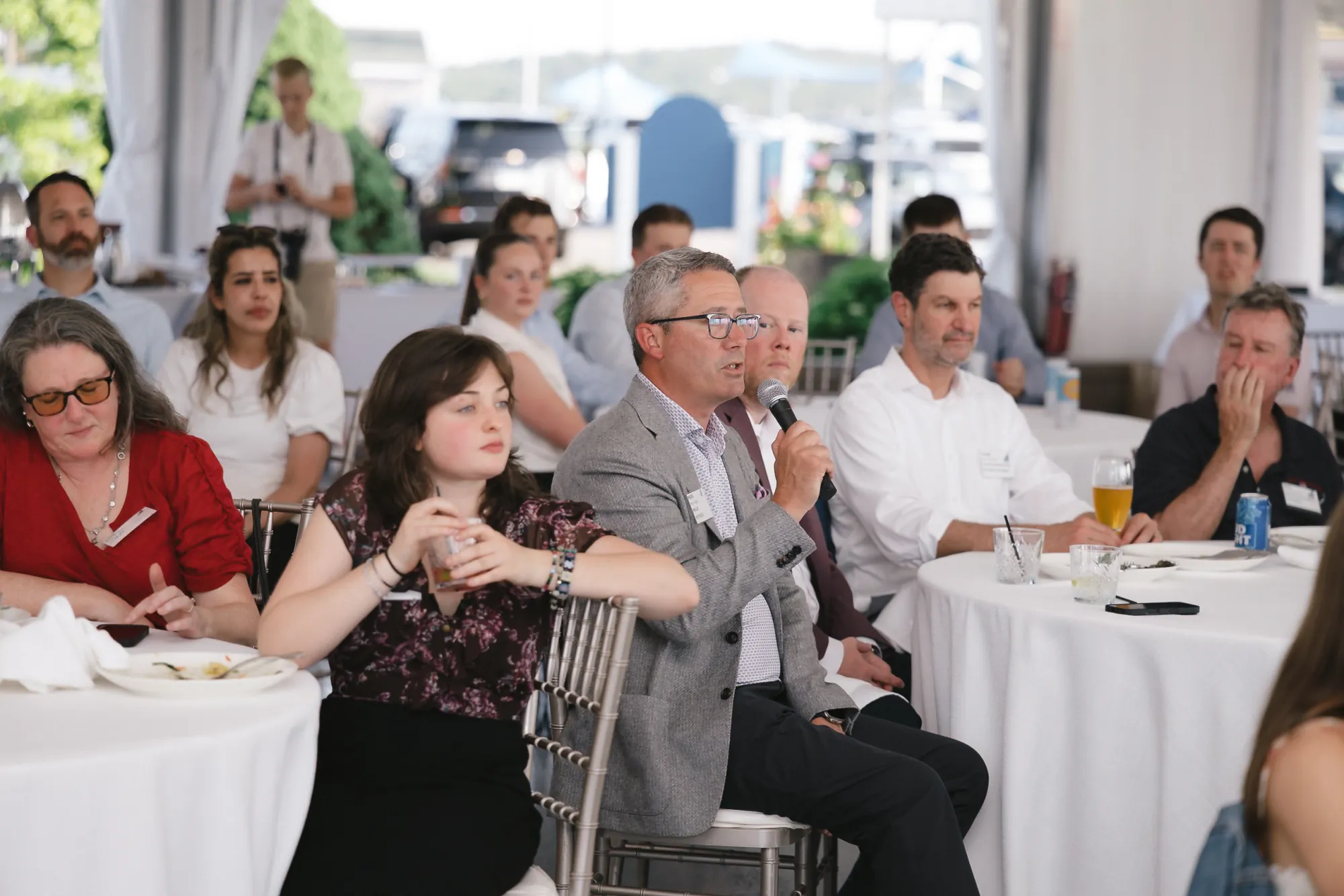 Attendee asking a question during the Q&A at the CFMA keynote, seated audience at Granite Links Golf Club, Quincy MA