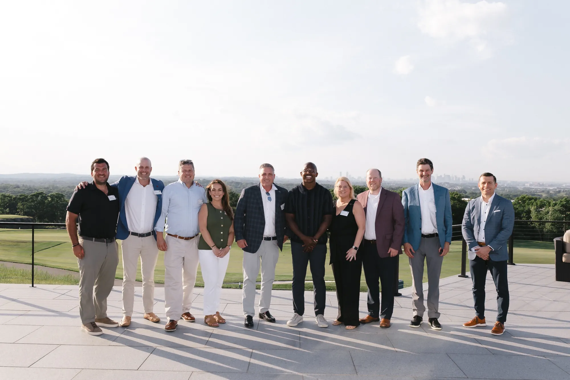 CFMA group photo with keynote speaker Matthew Slater on the Granite Links terrace overlooking the Boston skyline, Quincy Massachusetts
