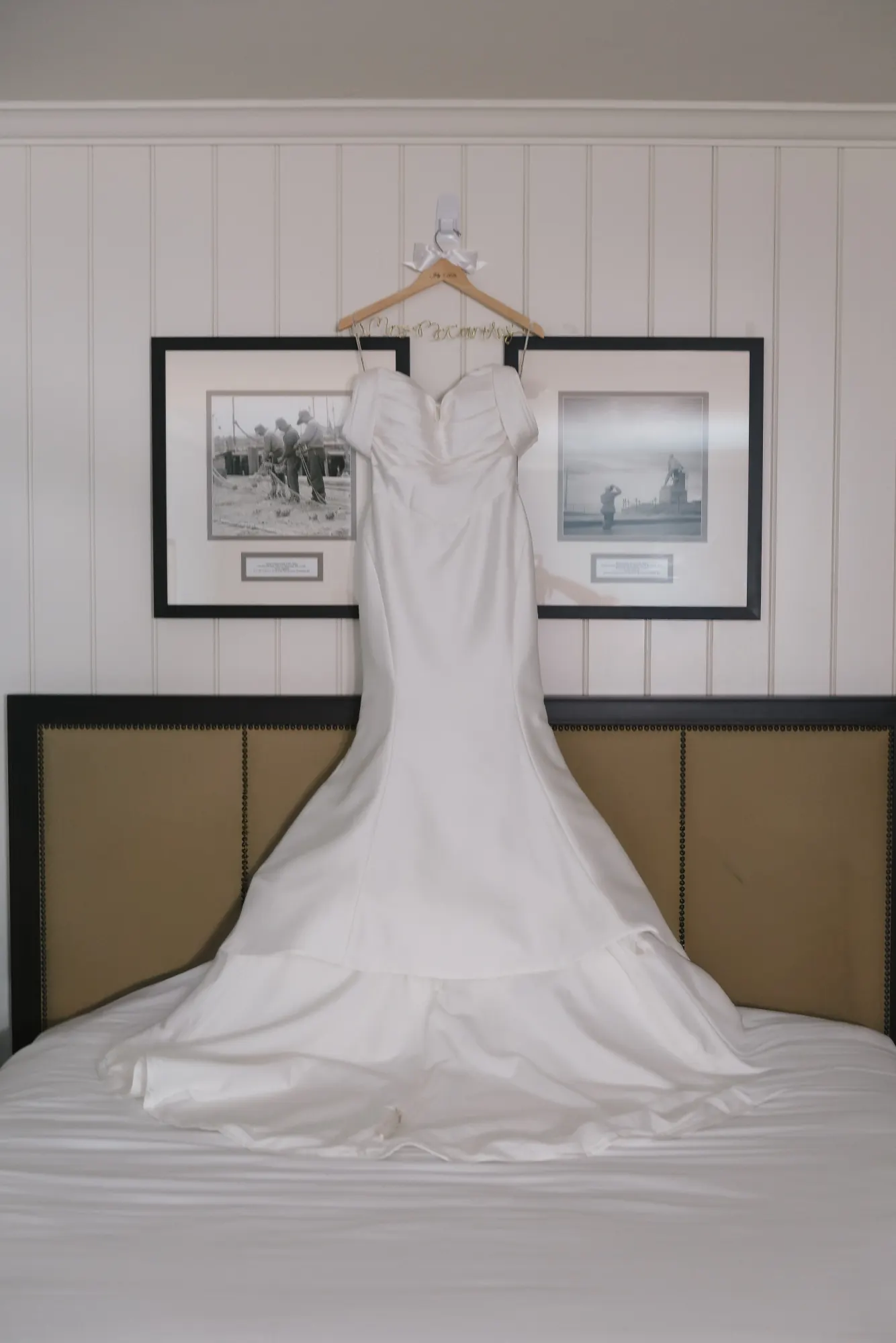 The bride's gown hangs above the bed in the Beauport Hotel suite