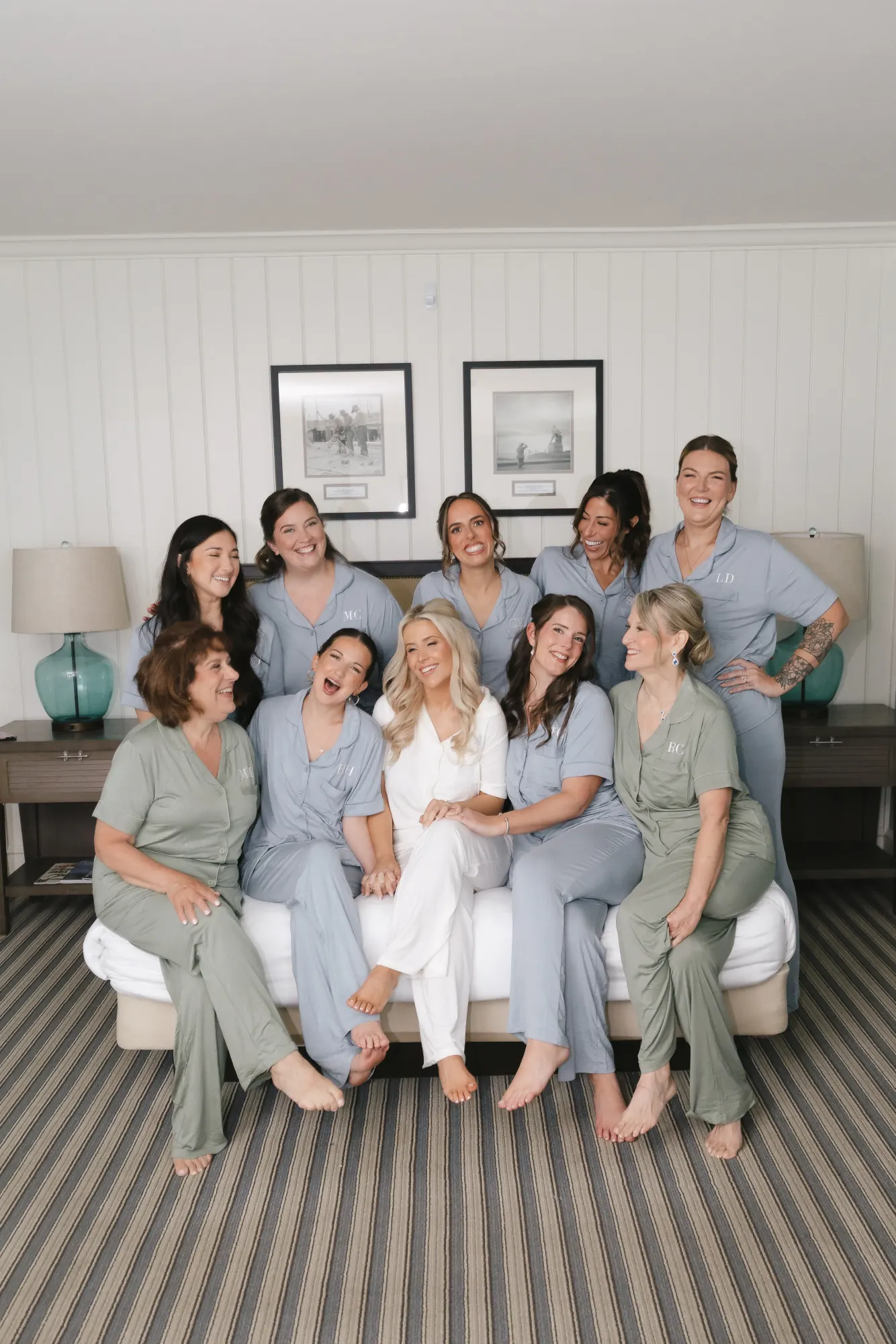 Bride and bridesmaids laugh together during getting ready