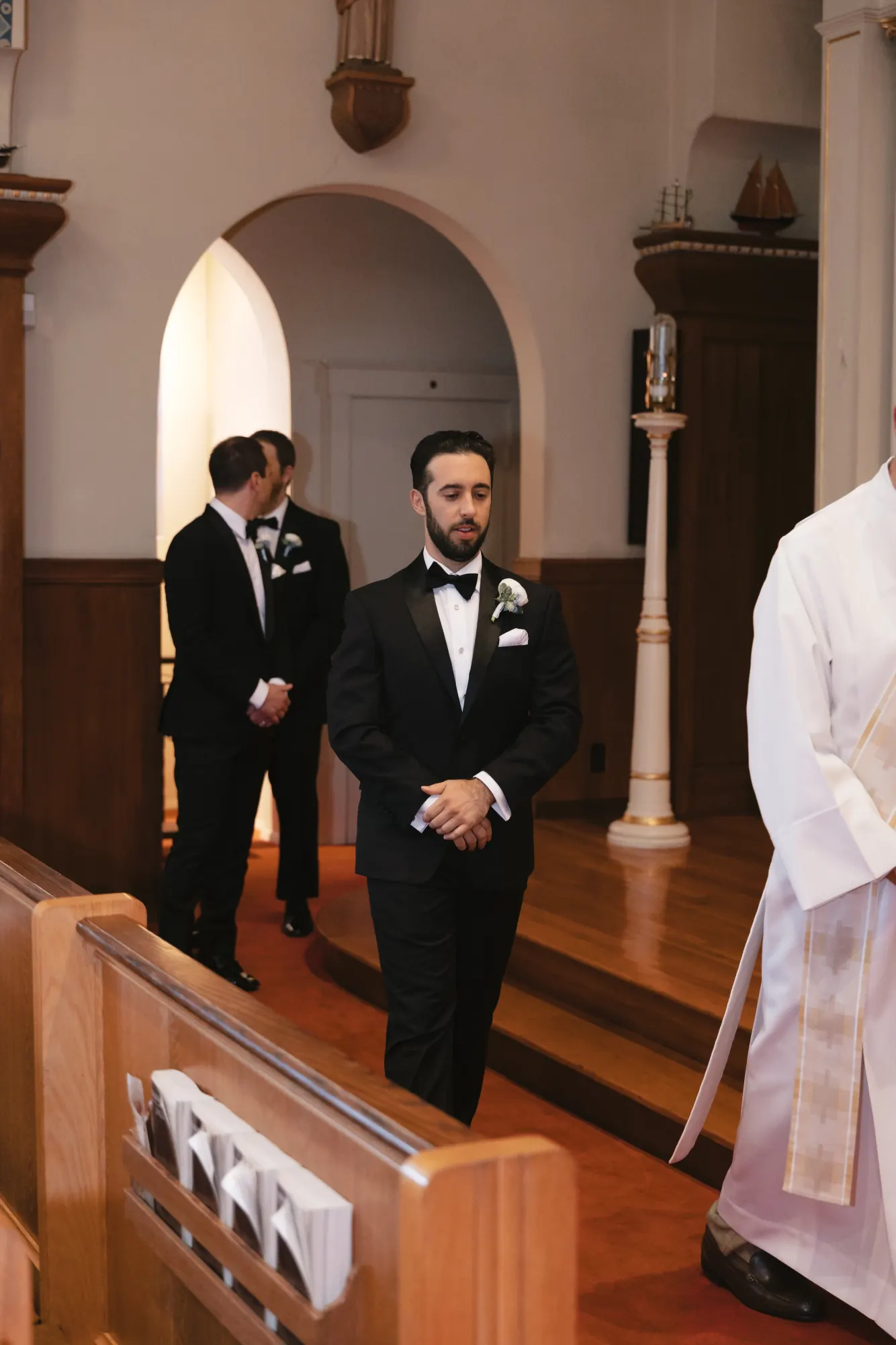 Groom and groomsmen wait inside Our Lady of Good Voyage in Gloucester