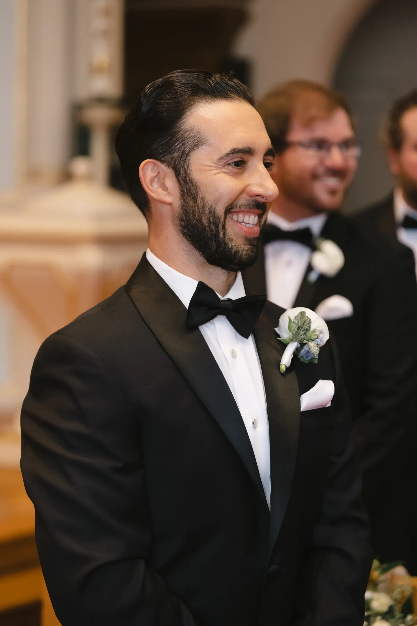 Groom smiles at the altar before the ceremony begins