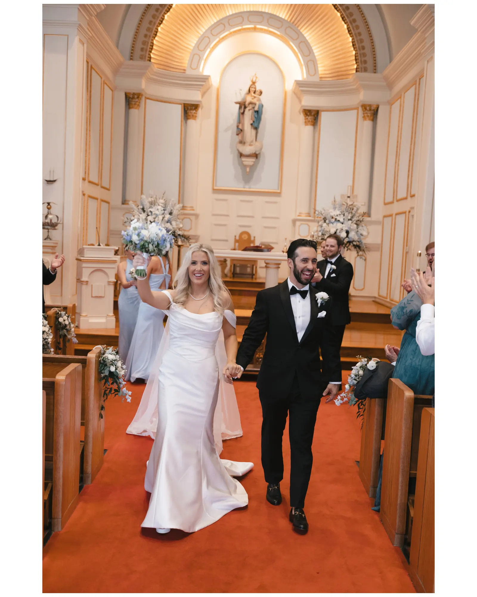 Newlyweds walk back down the aisle at Our Lady of Good Voyage