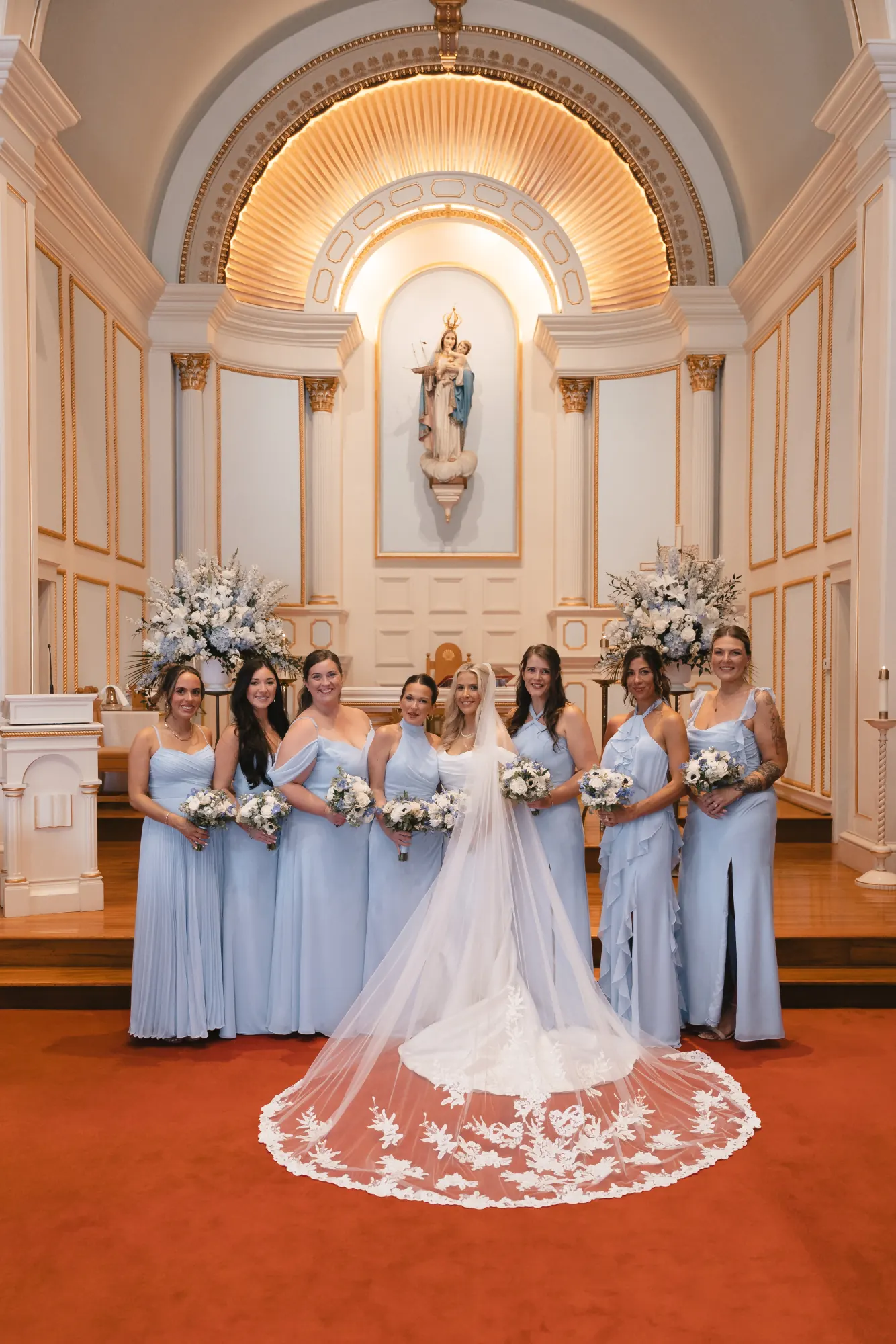 Bride with her bridesmaids in light blue at the altar