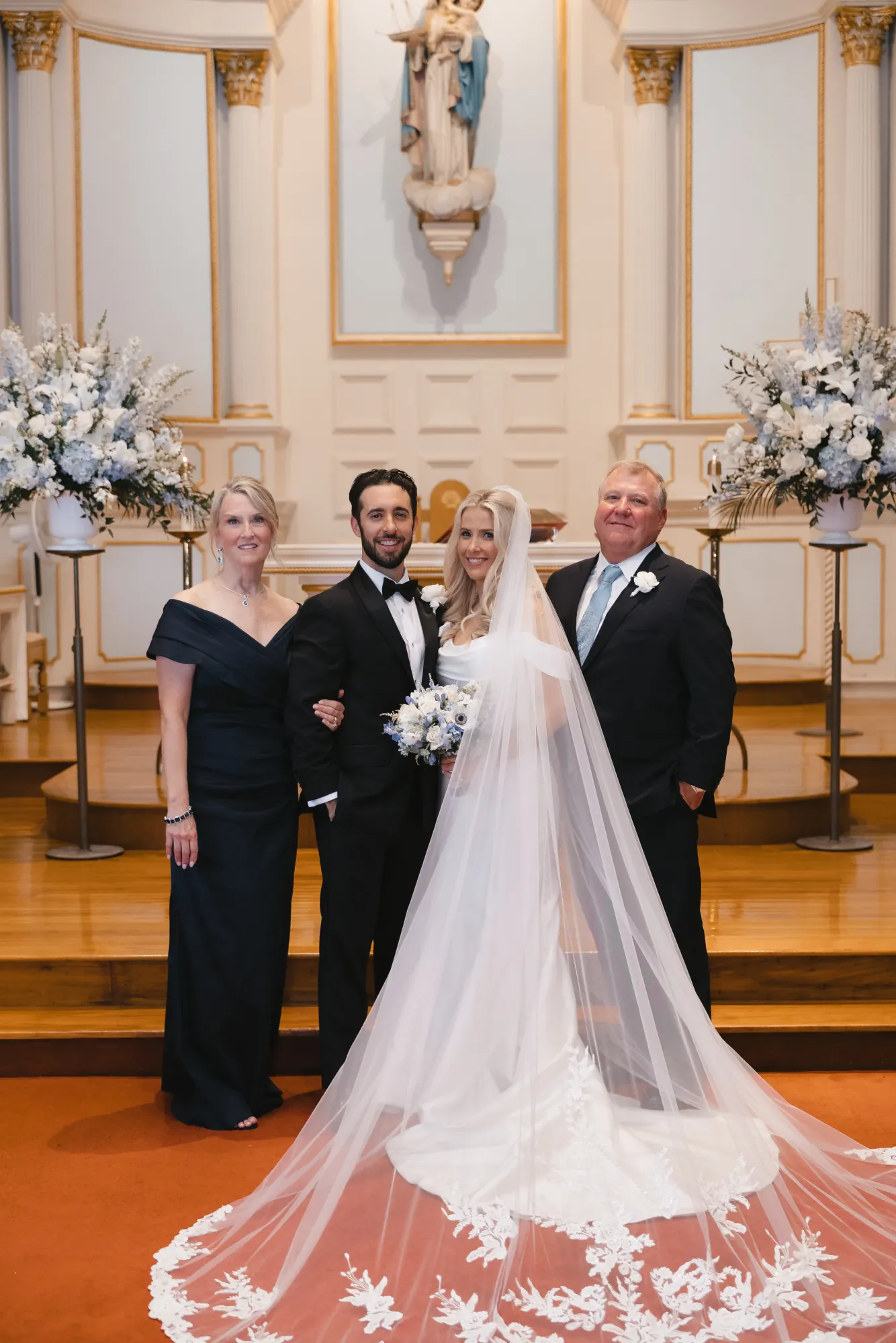 Bride and groom with parents after the church ceremony
