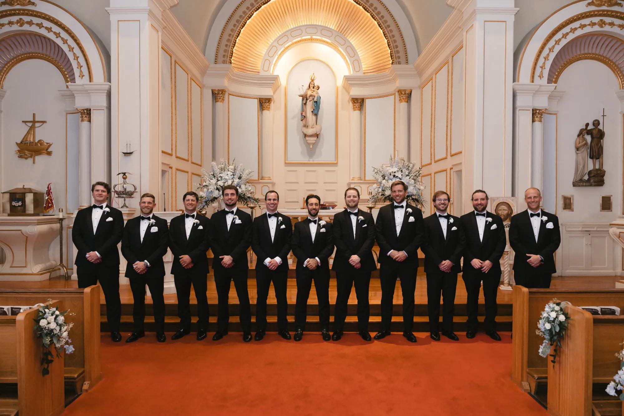 Groomsmen portrait across the altar of Our Lady of Good Voyage