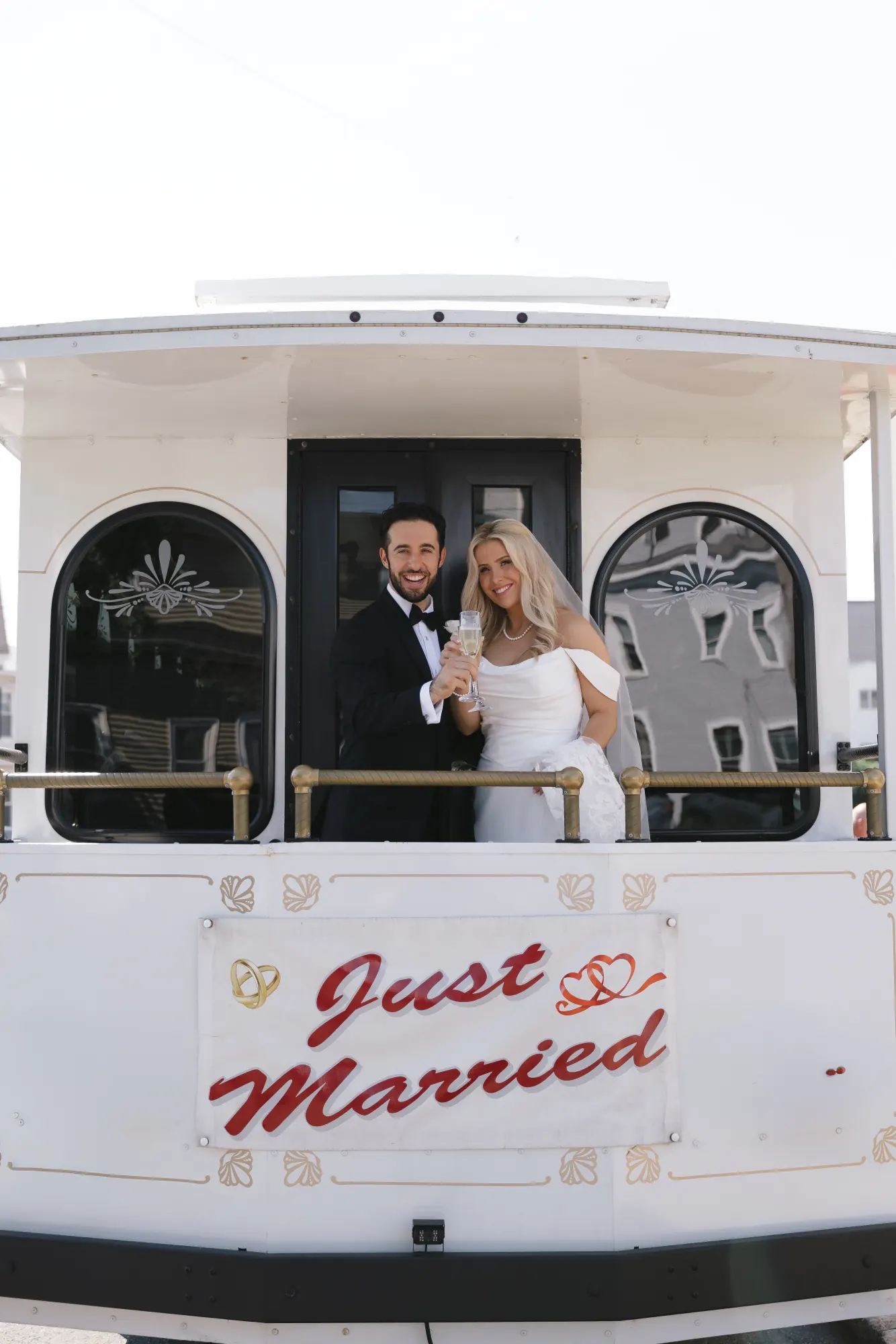 Newlyweds wave from the back of the Just Married trolley in Gloucester
