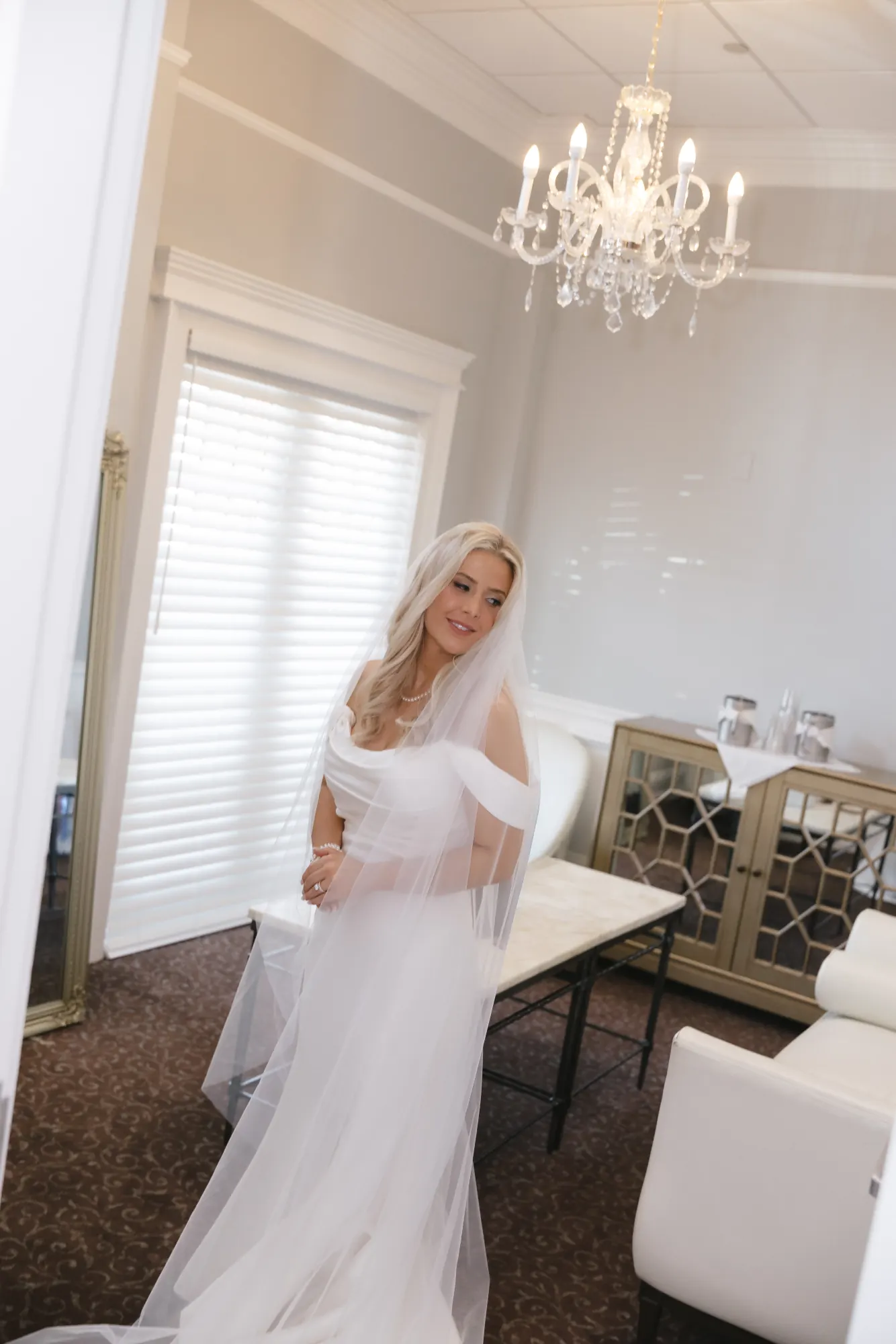 Bride beneath the chandelier in the lounge at Cruiseport Gloucester