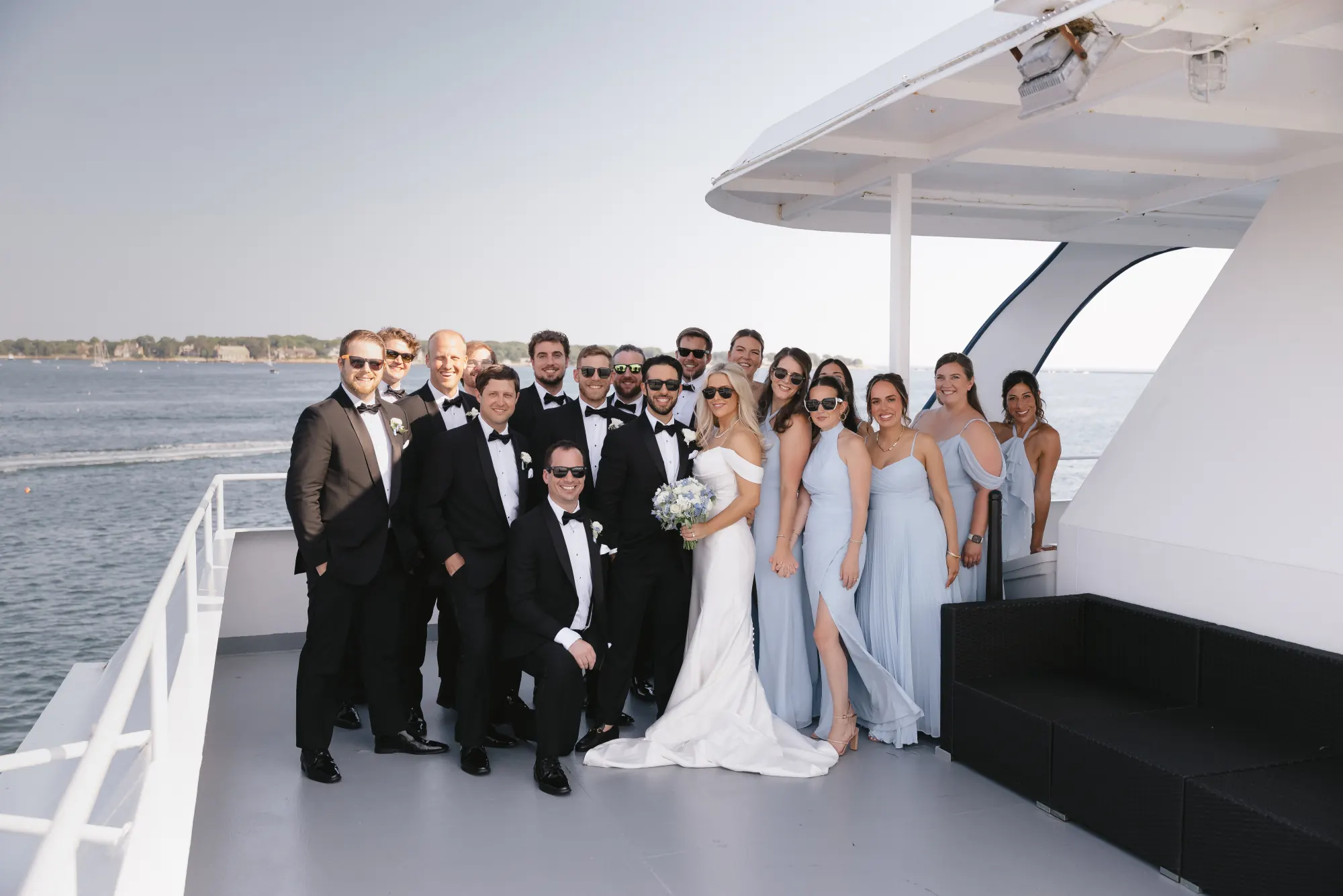 The wedding party gathers on deck during the cocktail hour cruise on Gloucester Harbor