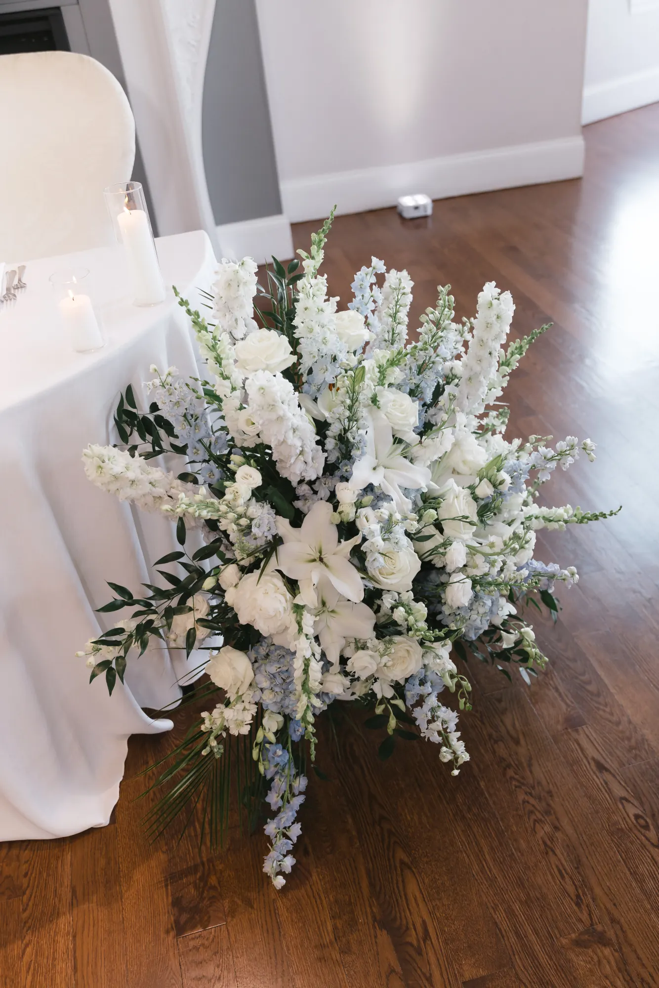 White and blue floral arrangement in the ballroom at Cruiseport Gloucester