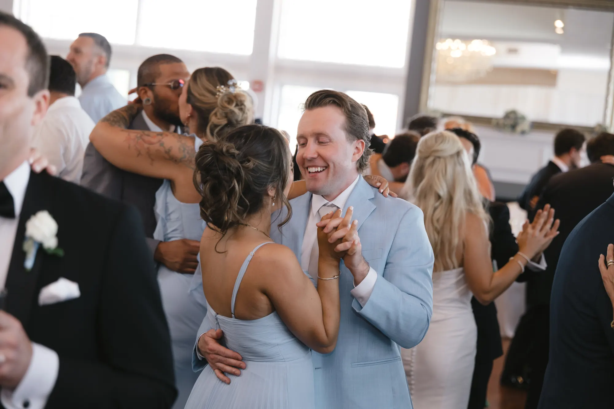 Guests laugh together on the dance floor at Cruiseport Gloucester