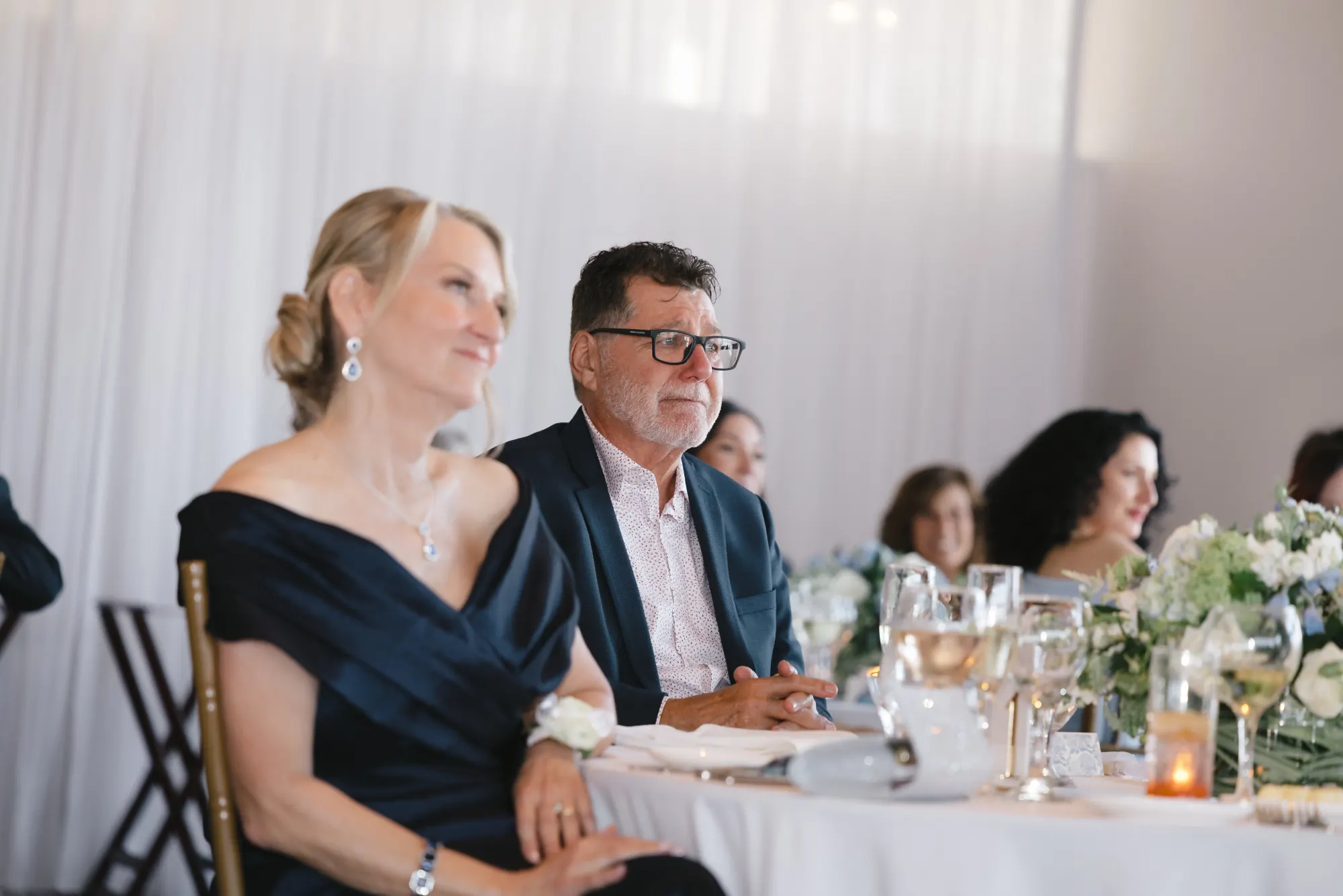 Guests react to the toasts at the Gloucester wedding reception