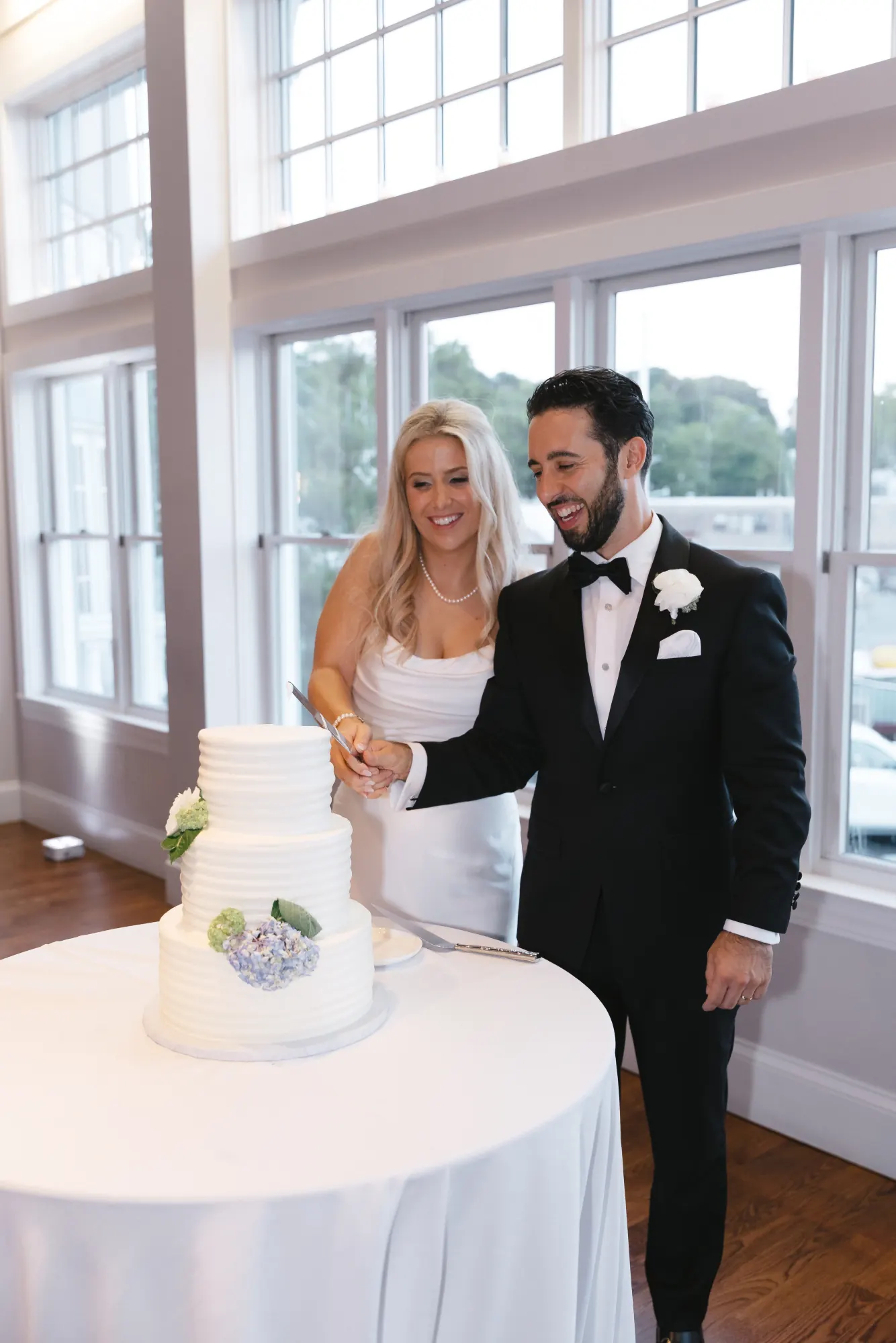 Cake cutting by the harbor-view windows at Cruiseport Gloucester