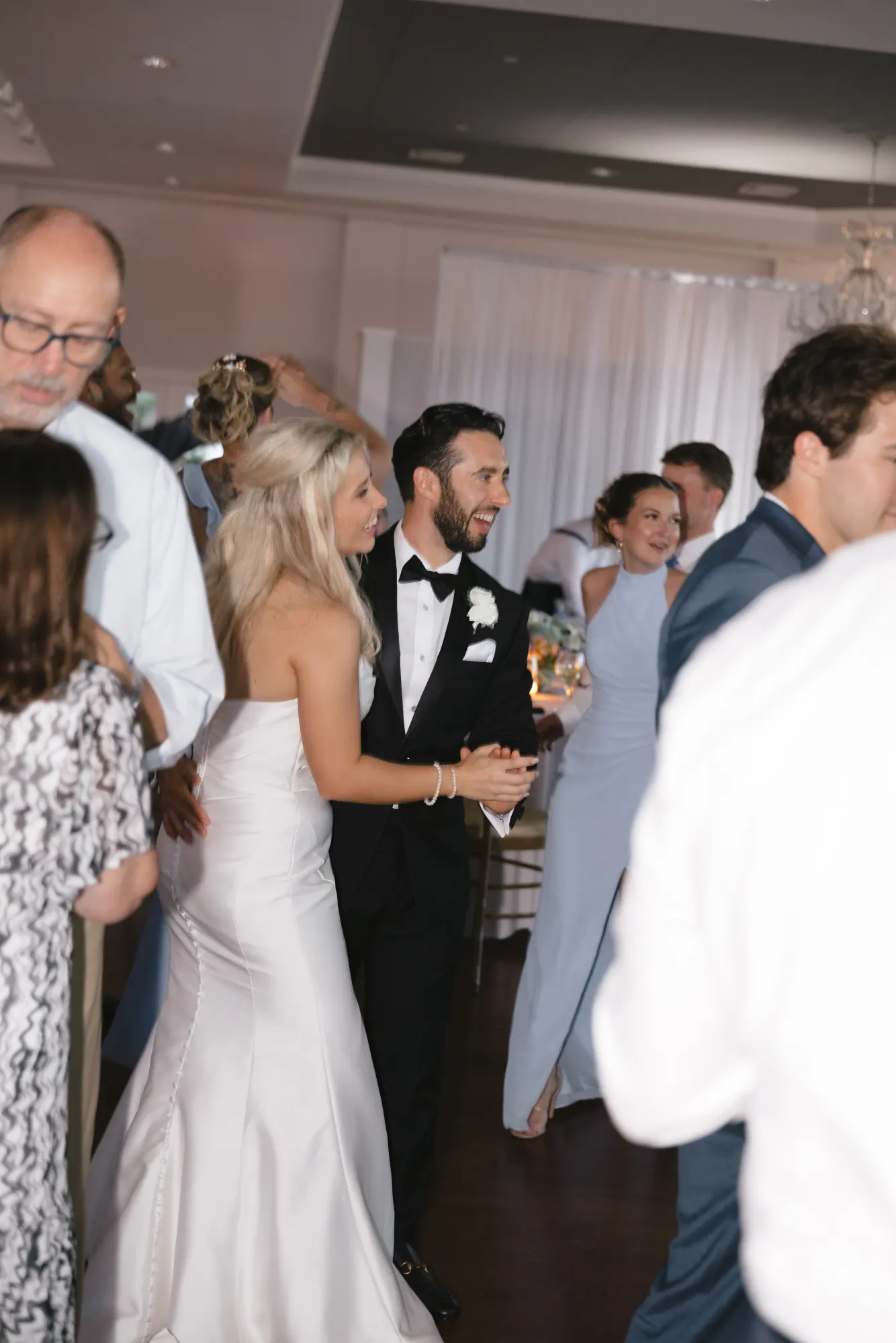 Bride and groom in the middle of the packed dance floor