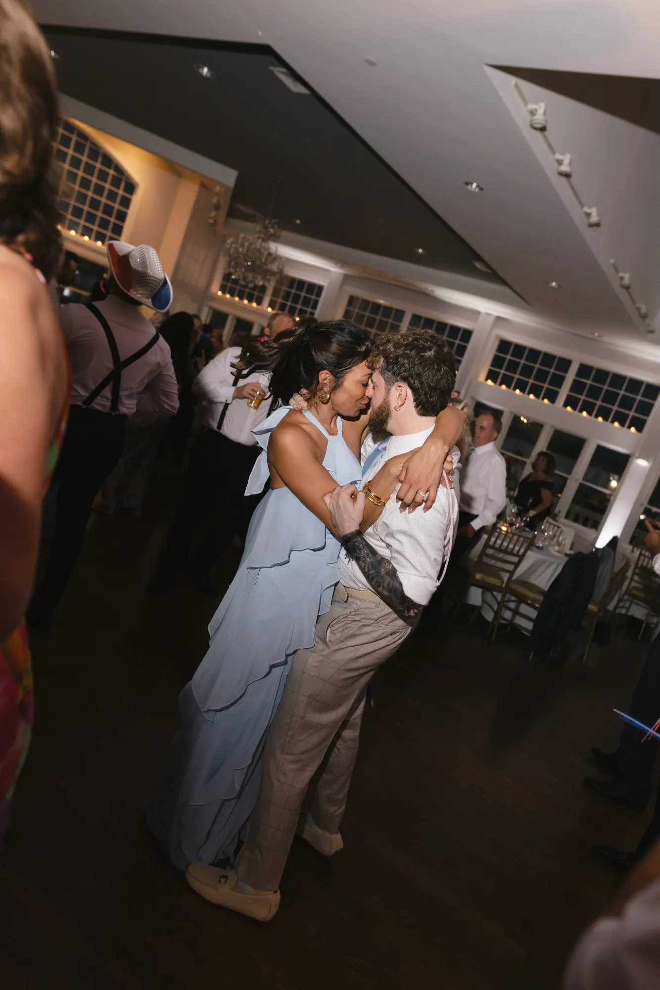 Guests slow dance under the ballroom lights