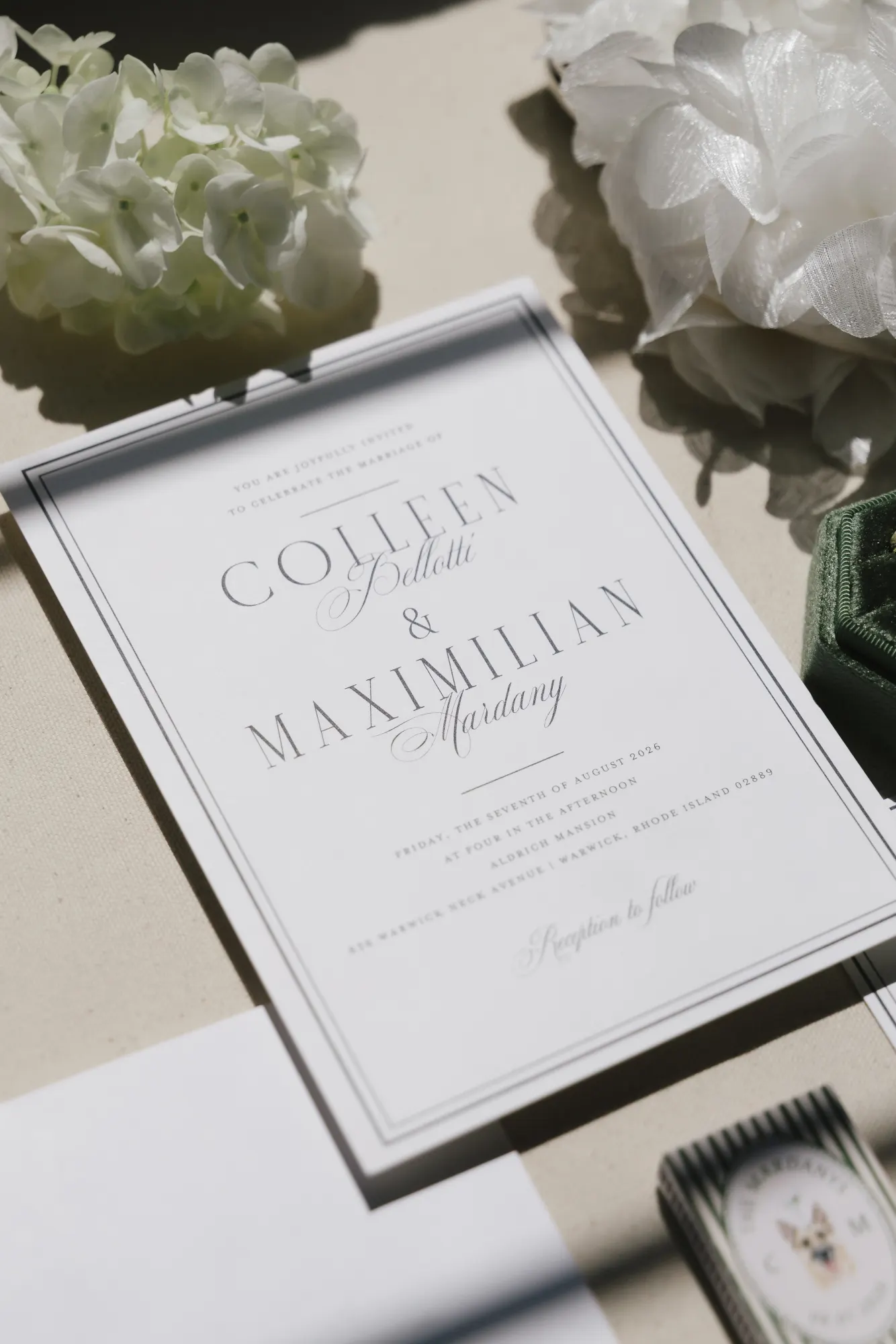 Colleen and Maximilian's wedding invitation styled with white florals