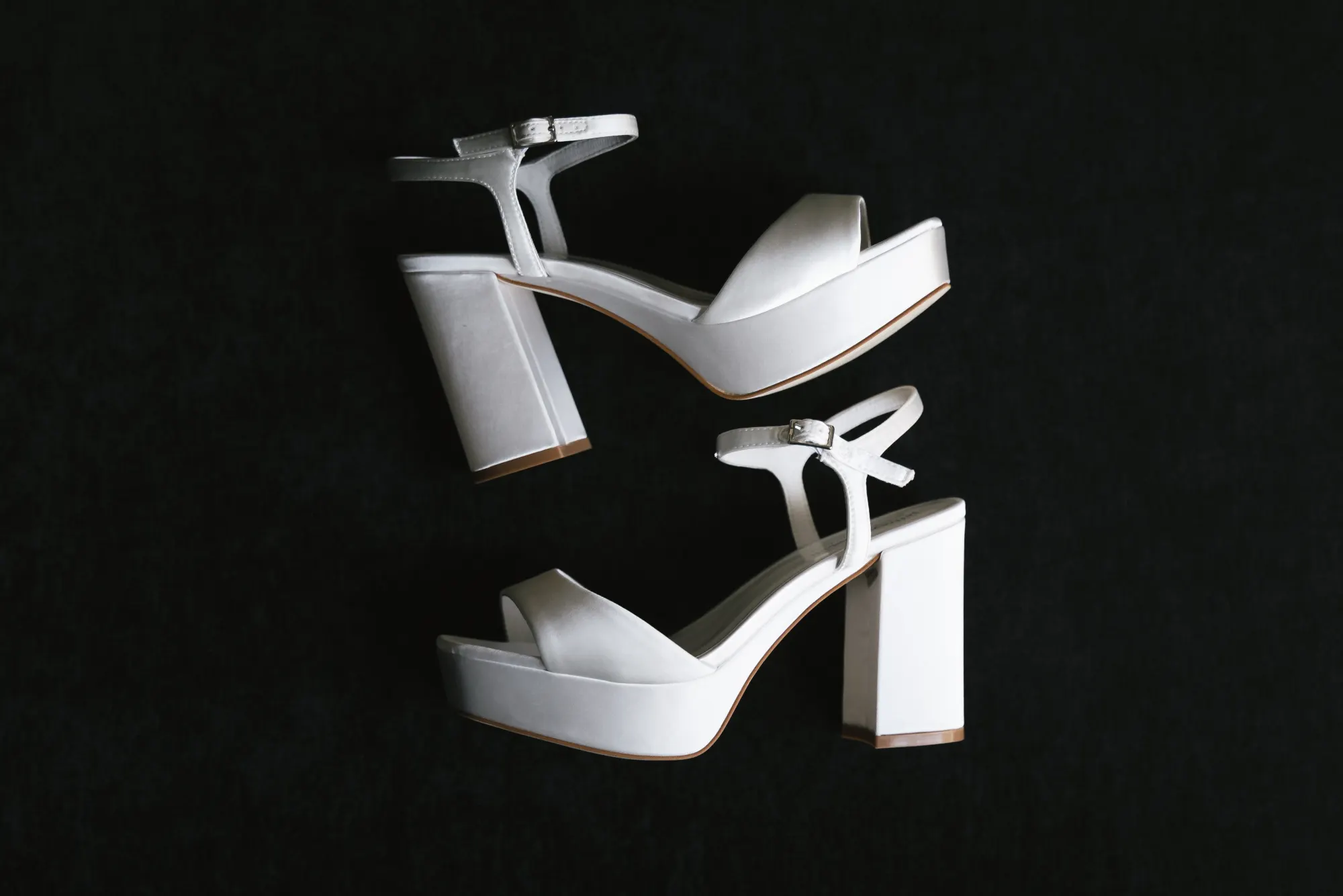 The bride's white platform heels on black