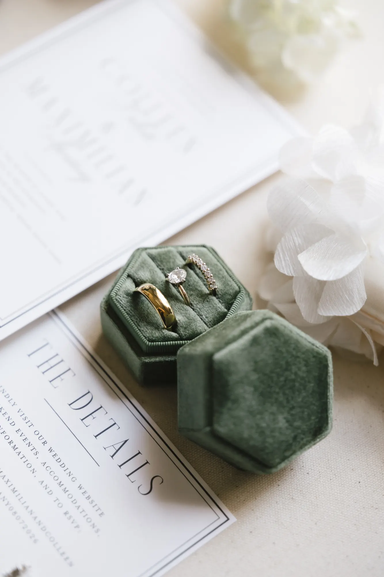 The rings in a green velvet box atop the details card