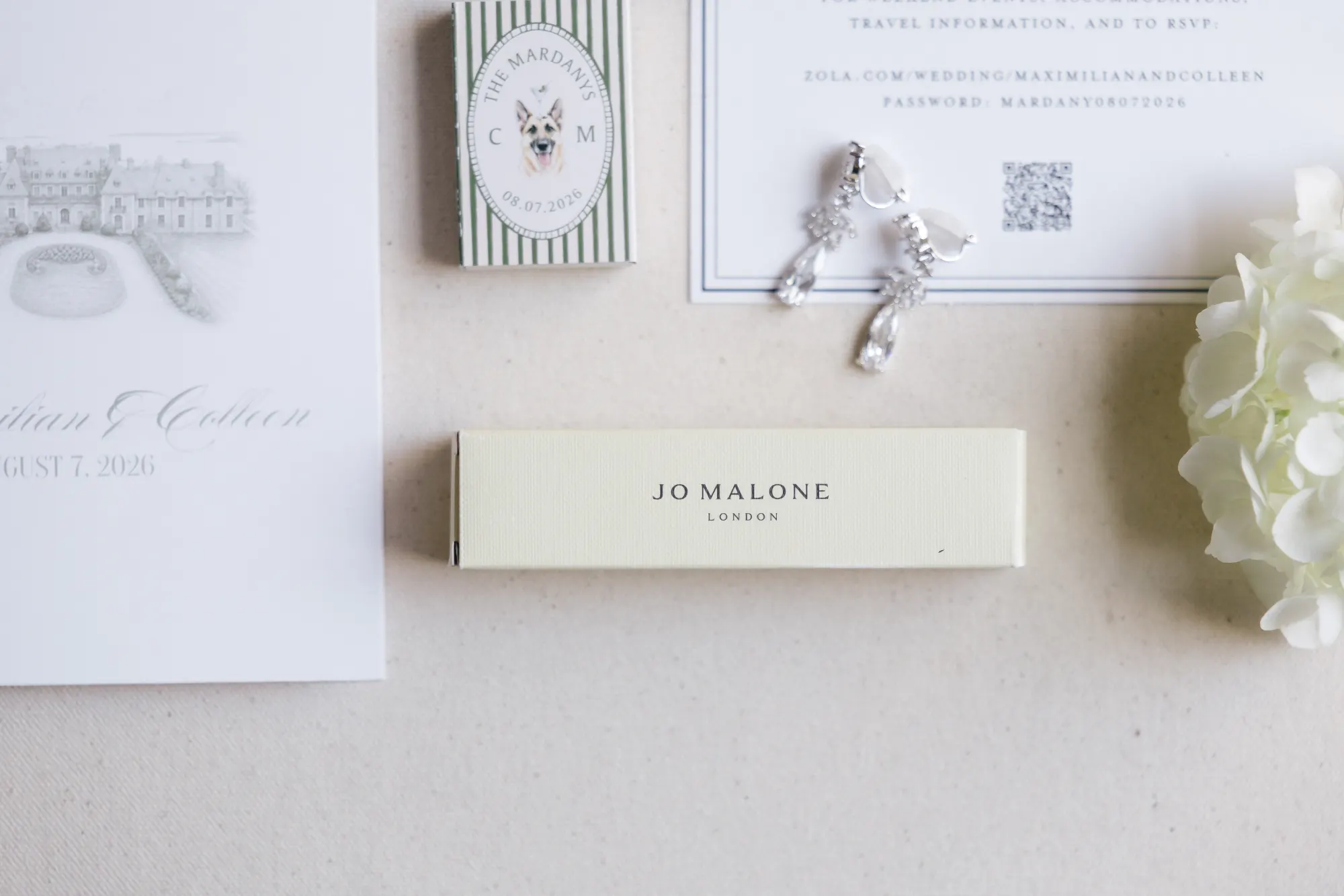 Travel details card with the bride's earrings and perfume