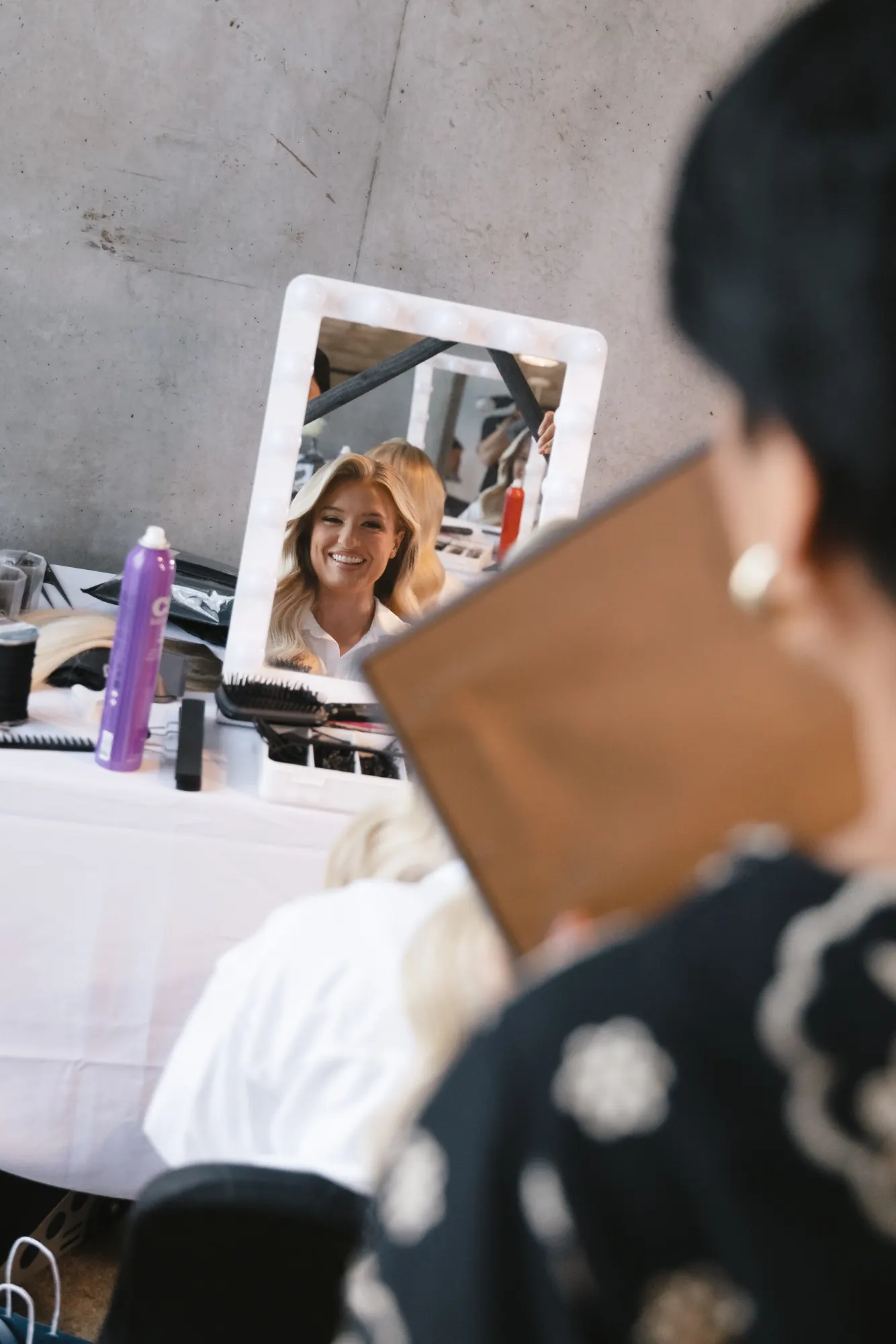 A quiet moment at the mirror during hair and makeup
