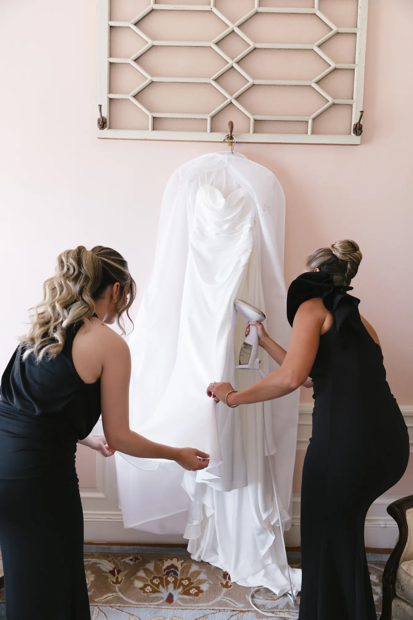 The gown comes out of its bag in the blush bridal suite at Aldrich Mansion