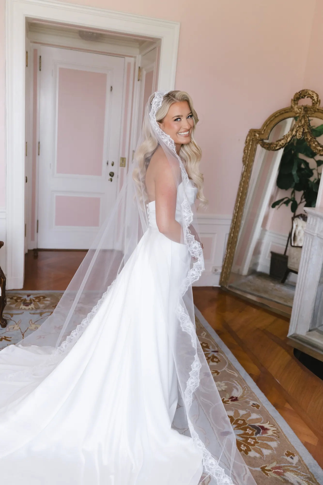 Full-length portrait of the bride with her cathedral veil and train