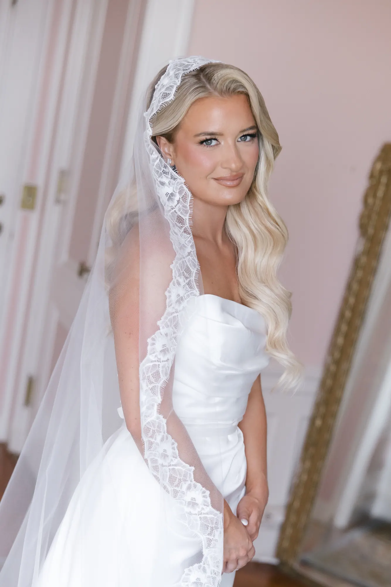 Bridal portrait with the lace-trimmed veil framing her face