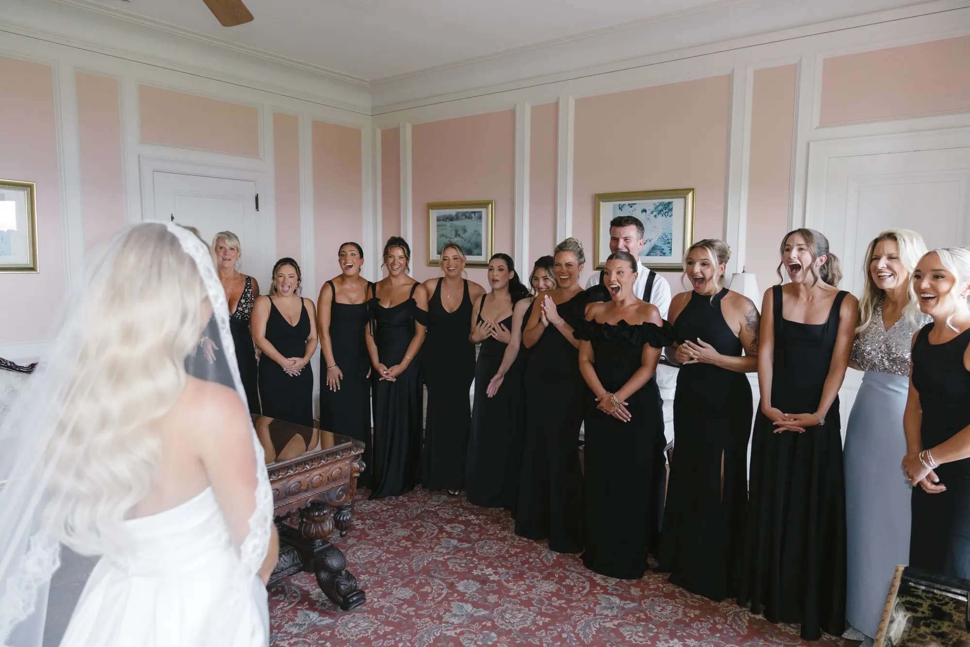 The bridesmaids in black see Colleen in her gown for the first time