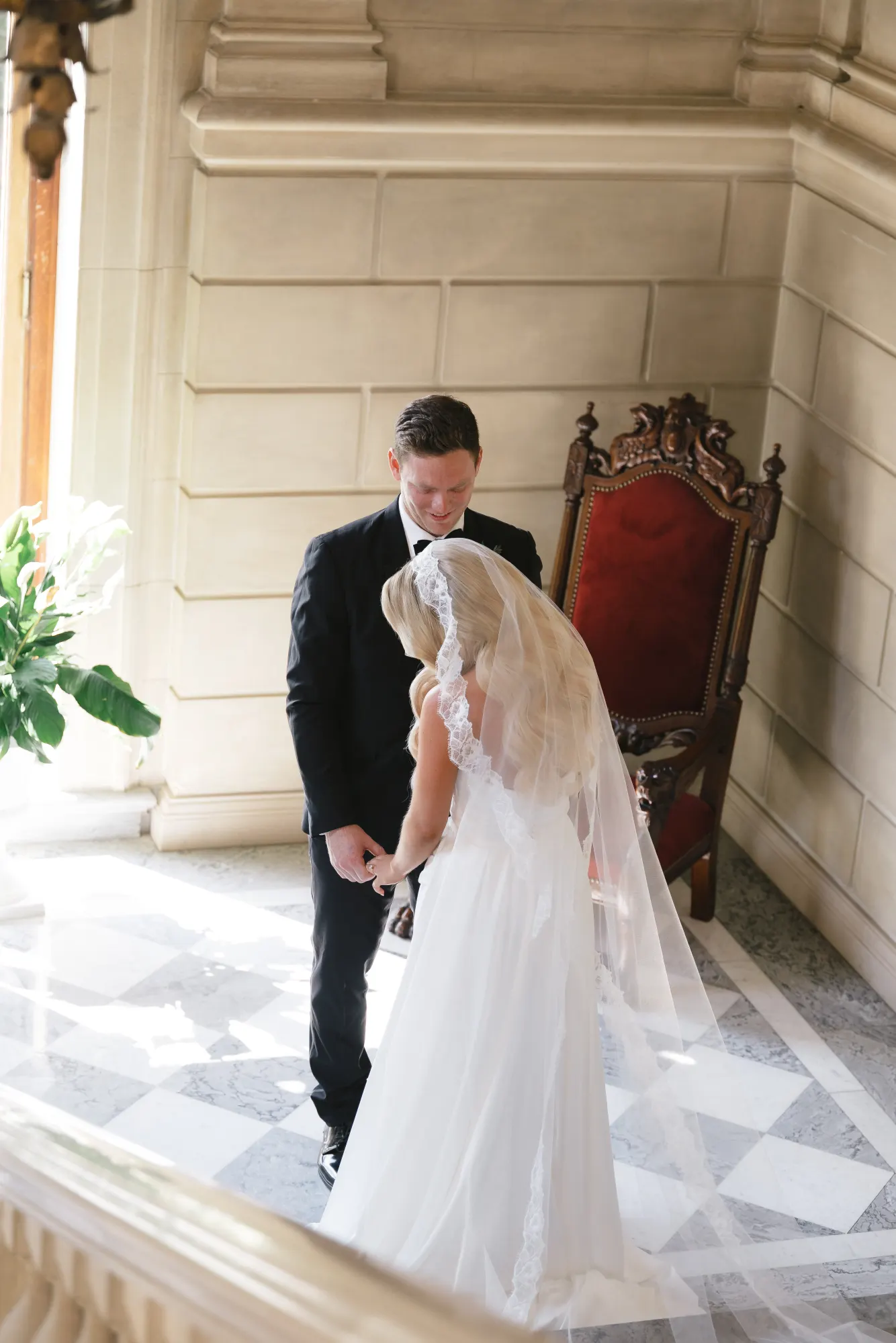 A quiet word between the couple on the marble staircase
