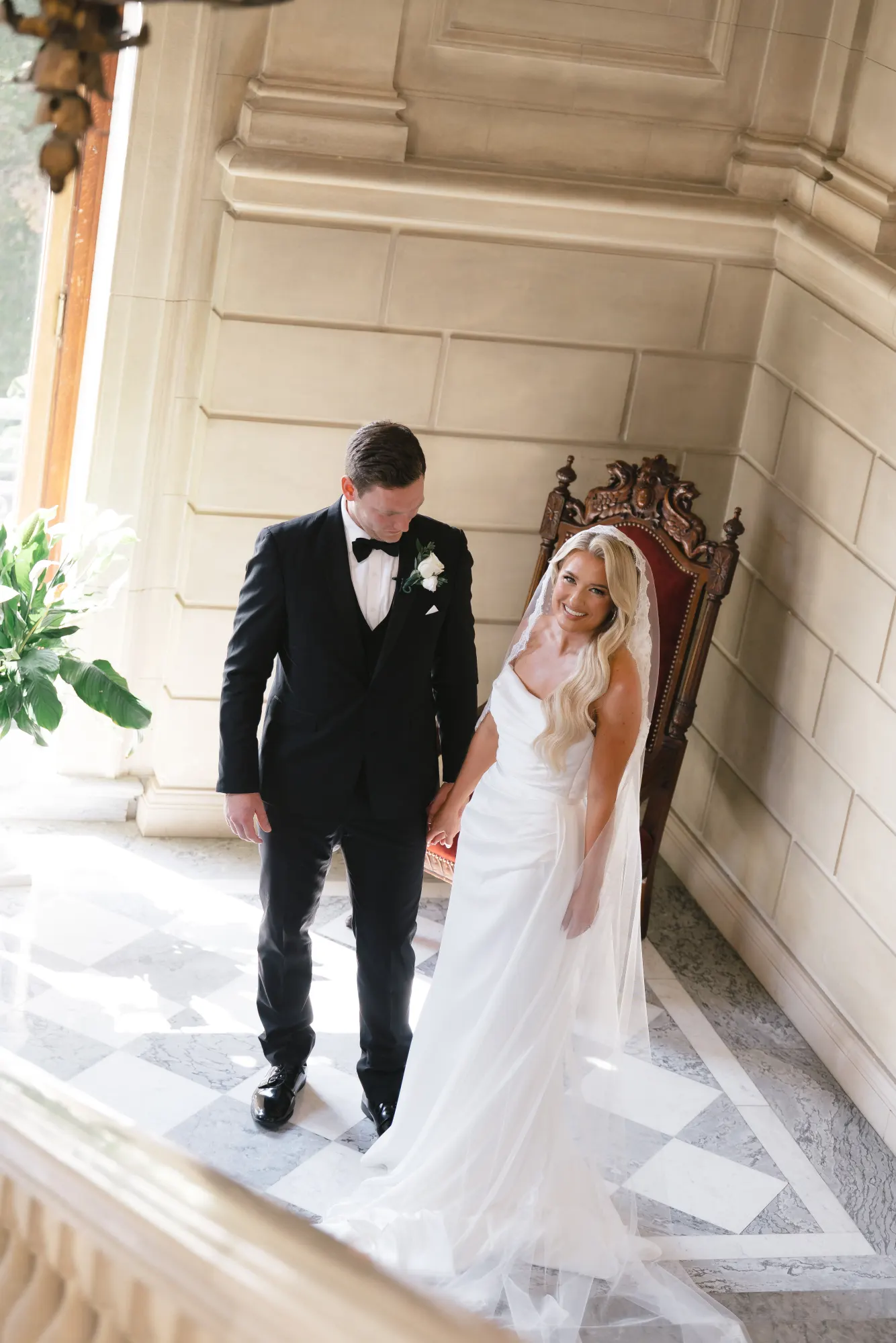 Colleen and Max descend the grand staircase hand in hand