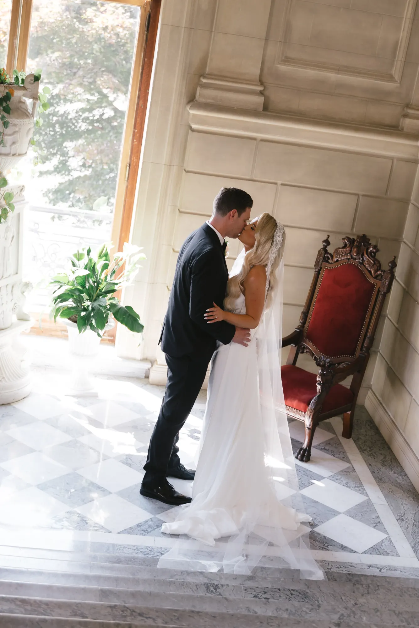 A kiss by the staircase window after the first look
