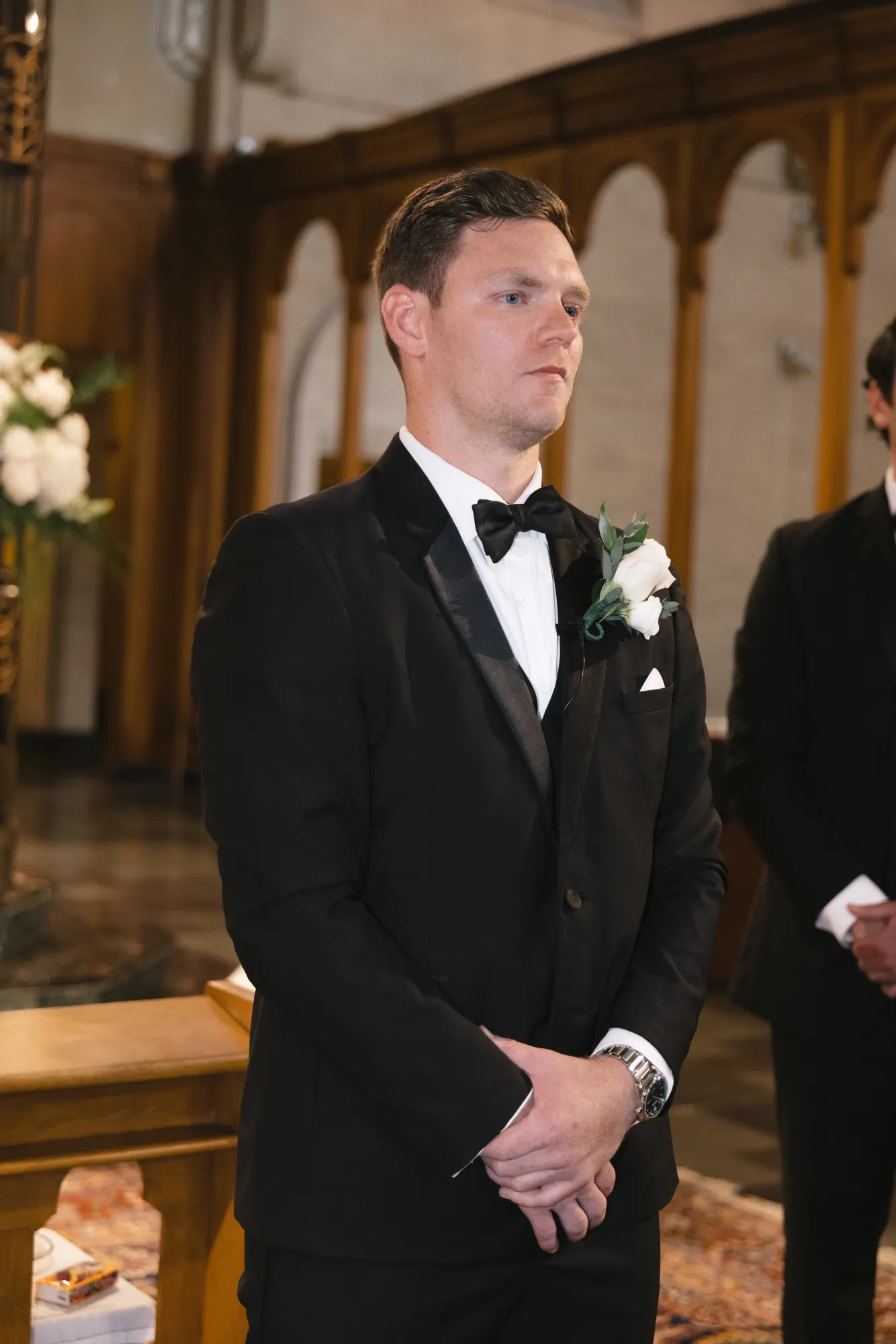 Max watches the processional from the altar steps