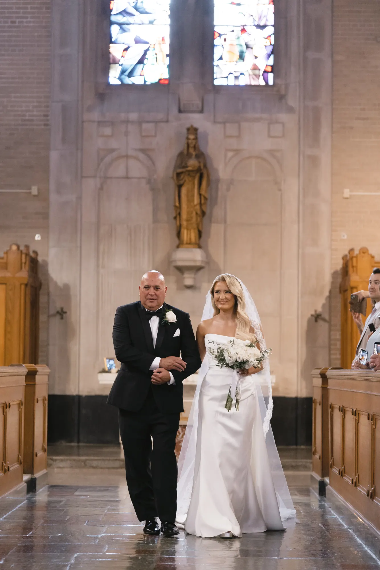 Colleen walks down the aisle on her father's arm