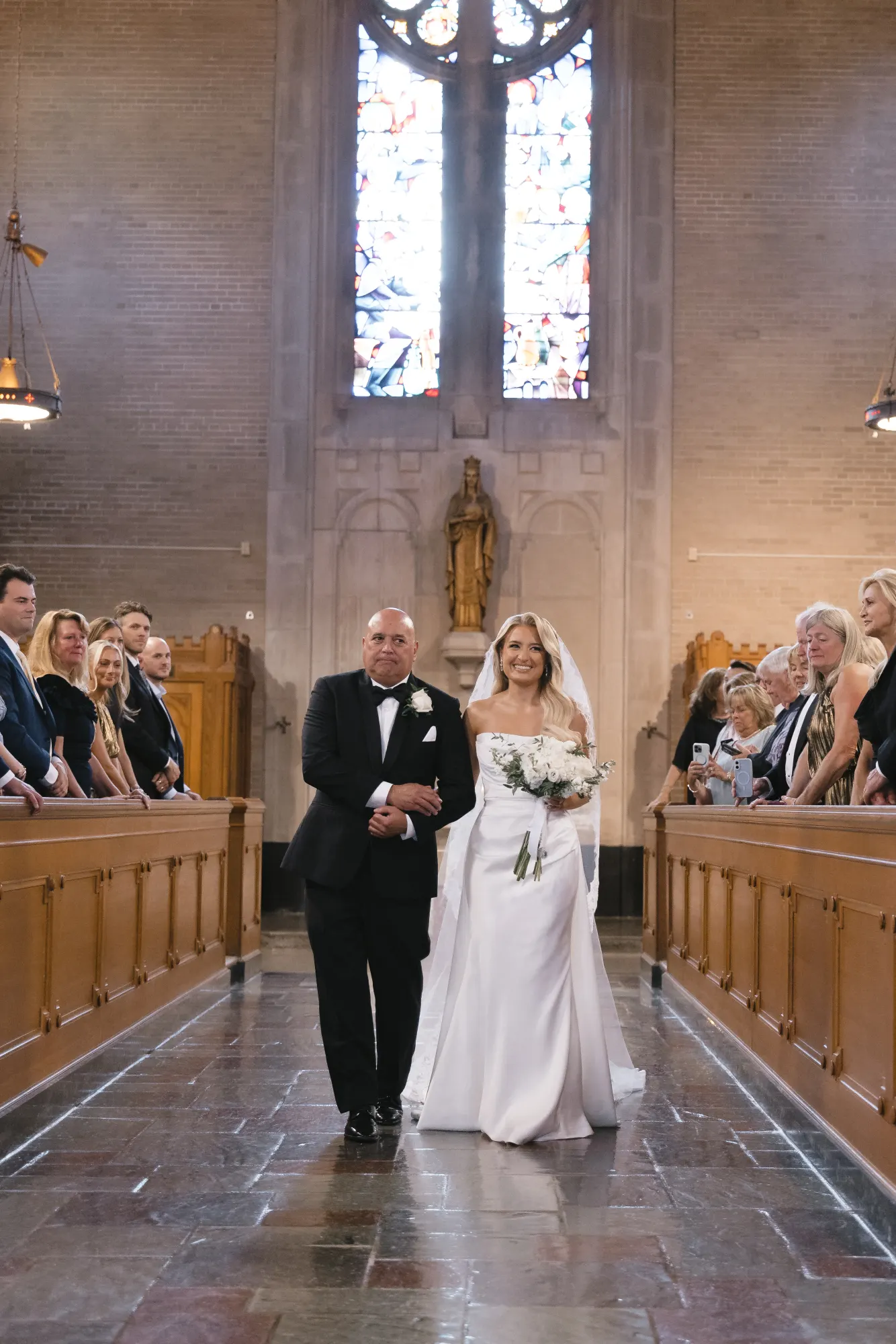 The bride and her father in the chapel aisle
