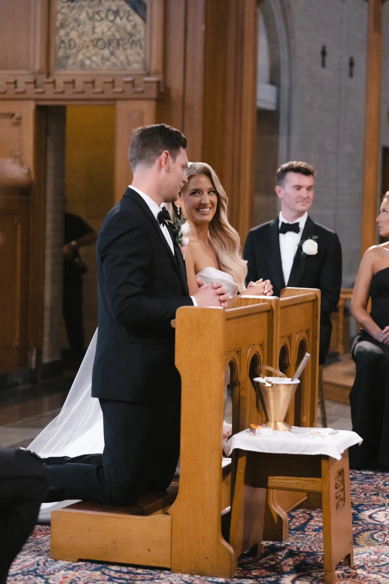 Colleen and Max share a laugh at the kneeler during the ceremony