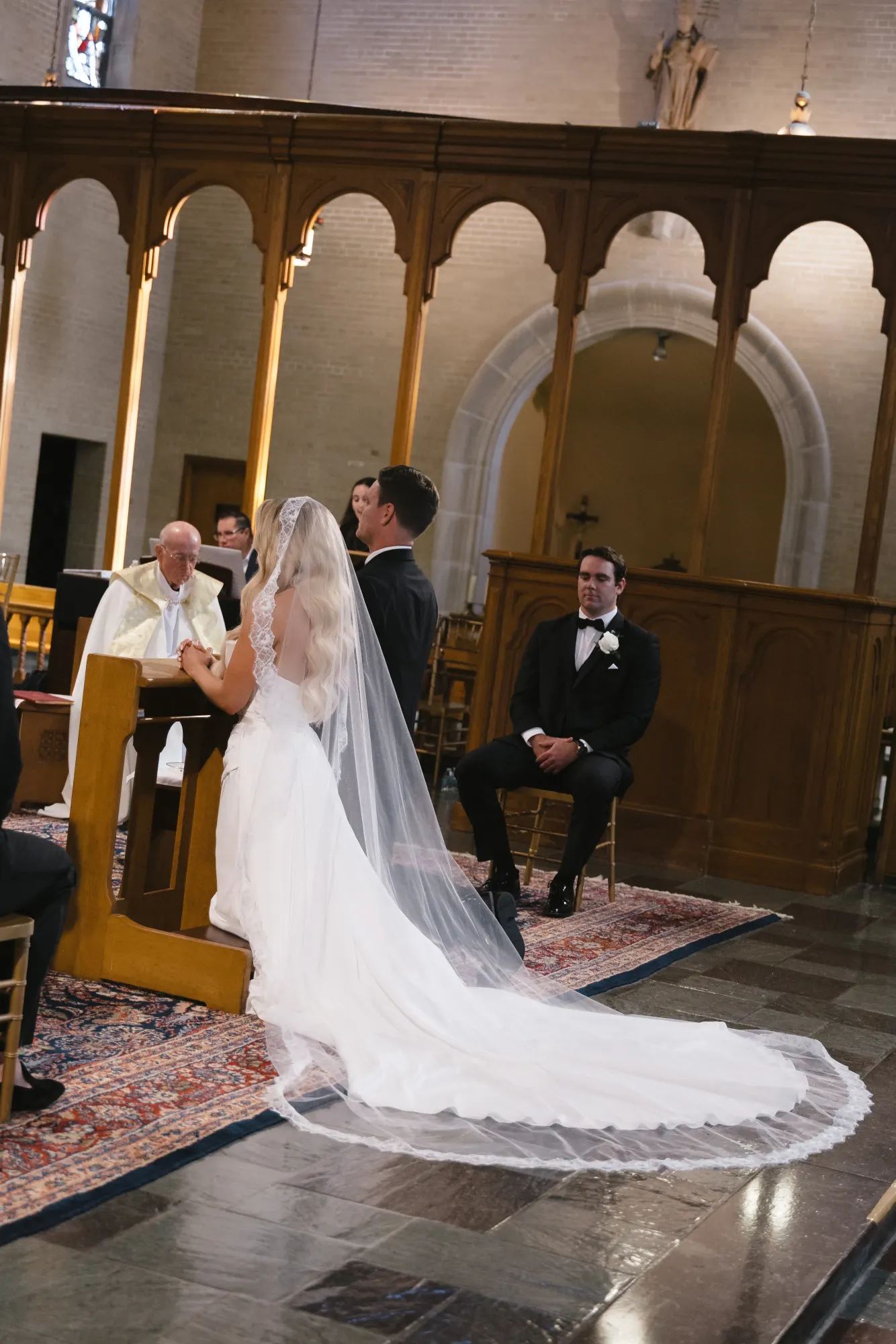 The cathedral veil trails from the kneeler during the mass