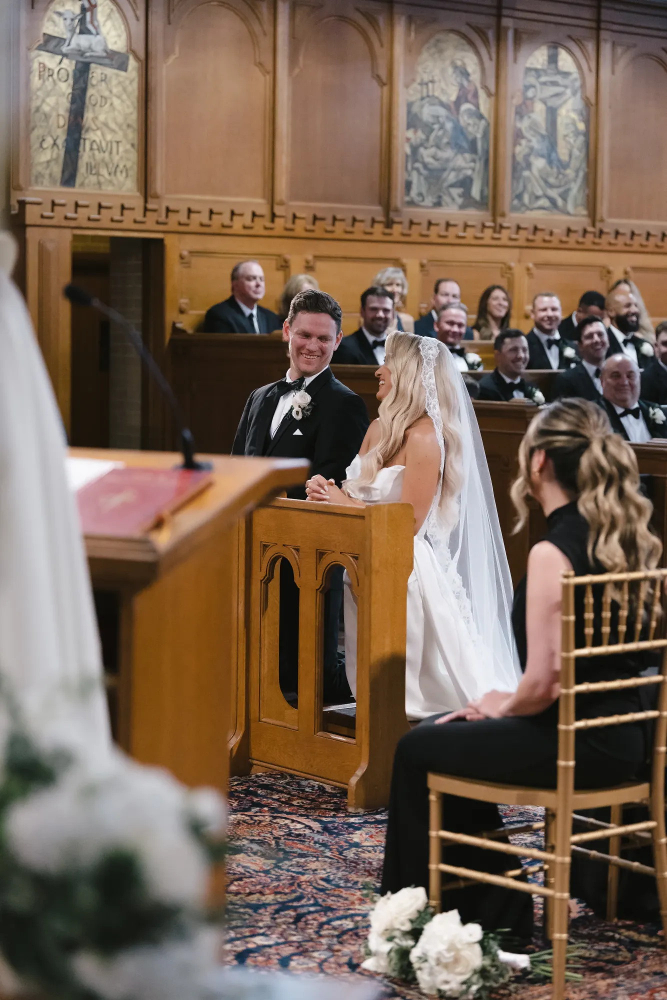 The couple at the altar as guests look on