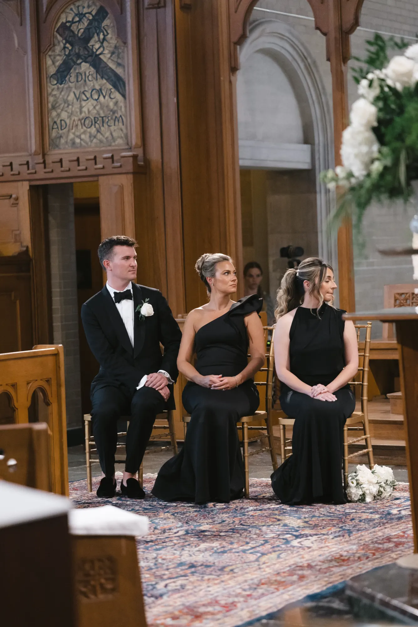 Seated guests follow the ceremony from the front pews